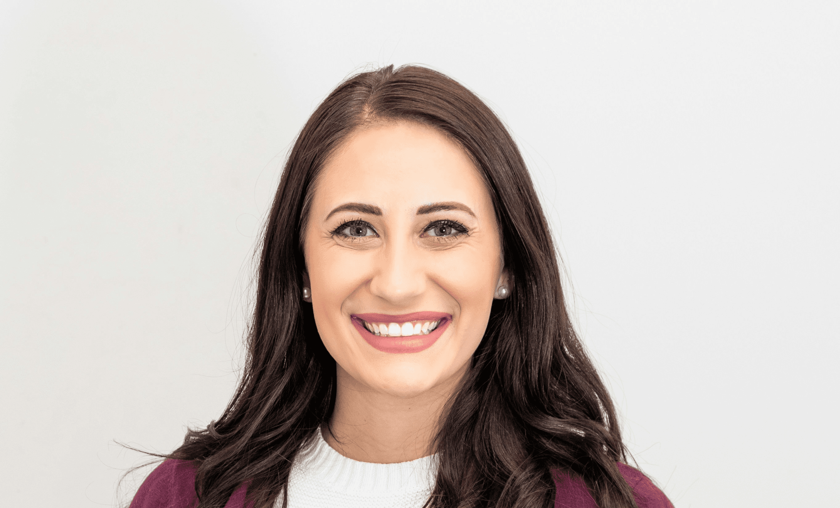woman in red cardigan smiling