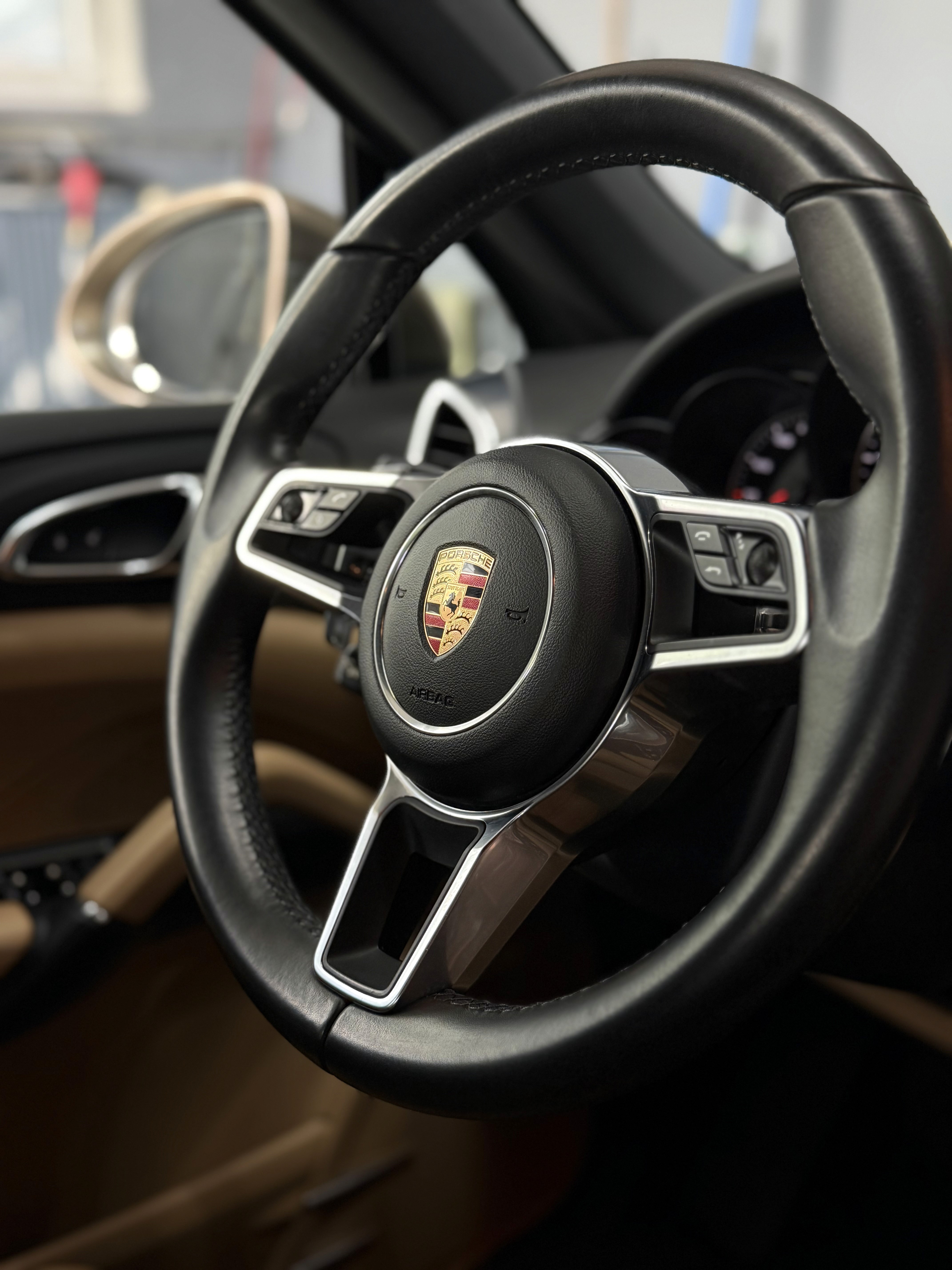 the steering wheel and dashboard of a car