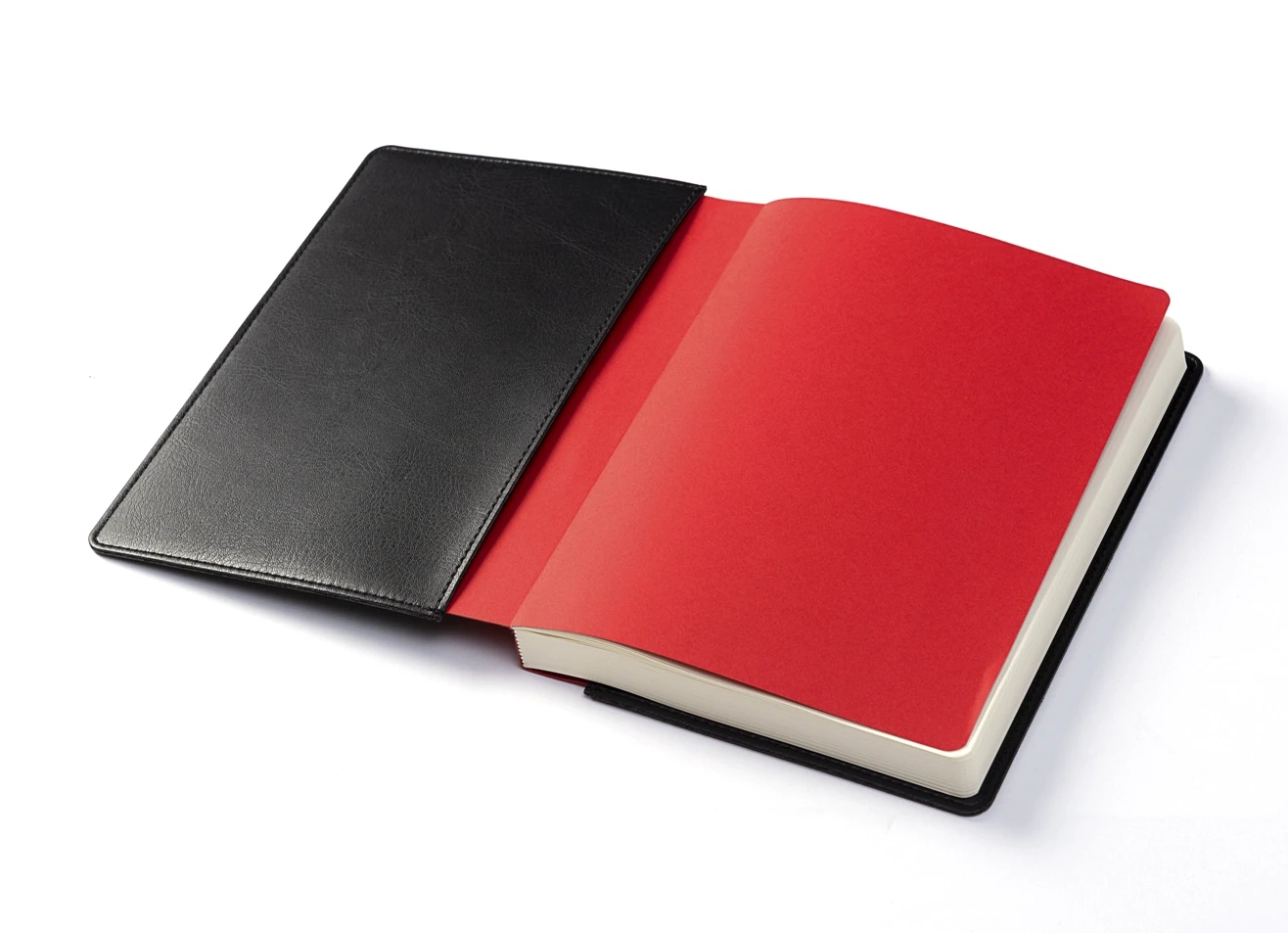 Open black sleeve showing the inserted red notebook and endpaper.