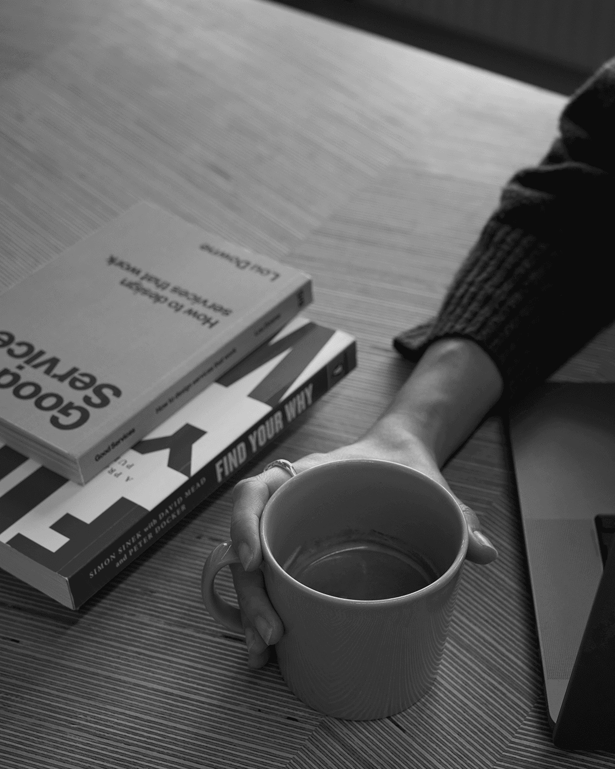 Image showing a laptop surrounded by design related books, and a mug