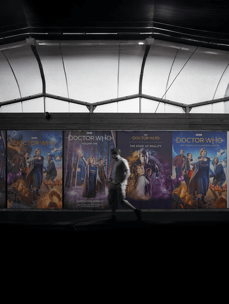 Blurred portrait of a person wallking past several Doctor Who posters