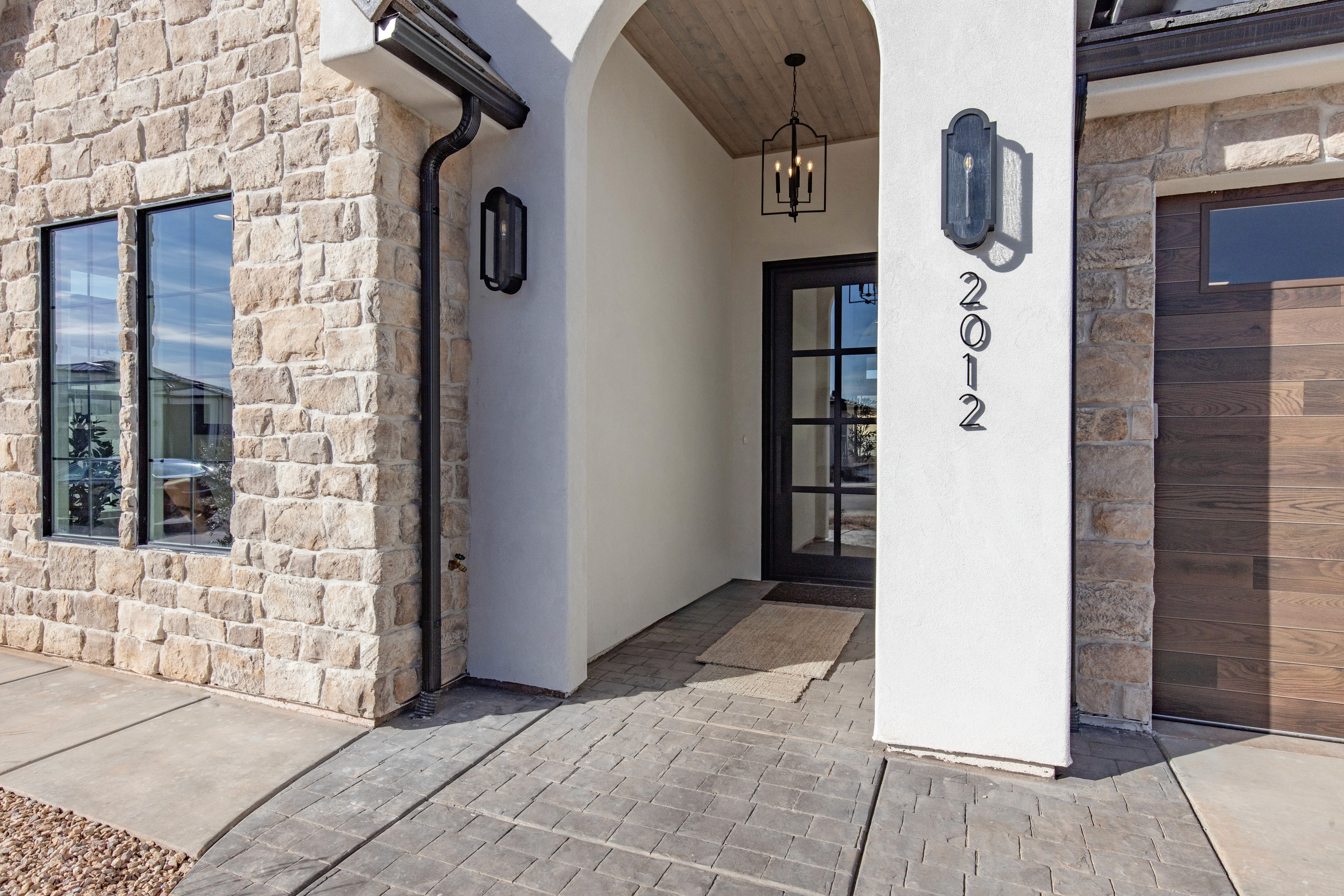Exterior entry chandelier in a Southern Utah custom home with stone and stucco finishes