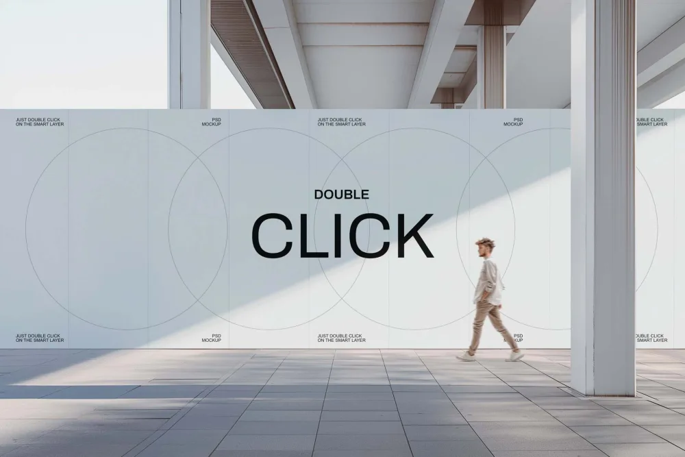 Large outdoor wall mockup in a modern architectural setting, featuring a minimalist design with light tones and circular patterns. A man walks by, adding depth to the scene.