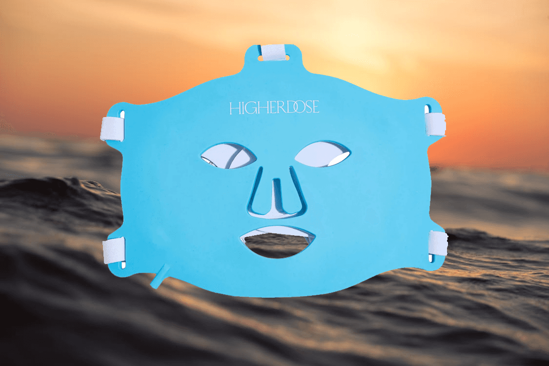 man filming on beach