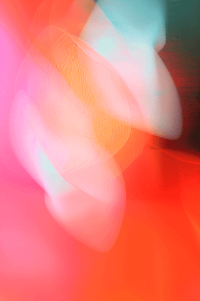Abstract image with vibrant pink, red, and orange hues blending into soft, flowing shapes. The ethereal atmosphere conveys warmth and movement.