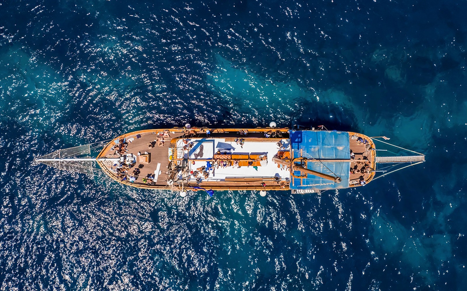 Turkish gulet sailing from Sliema to Gozo and Comino, passengers enjoying lunch on deck.