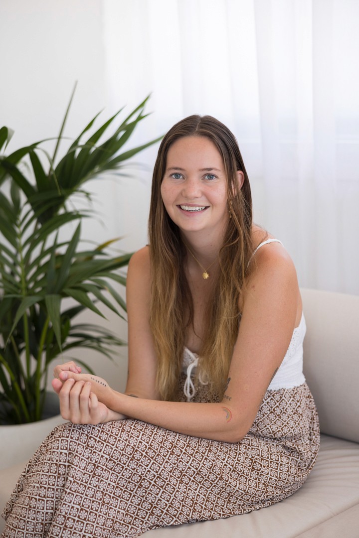 Young woman sitting with hands folded