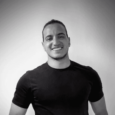 Profile portrait of a man in a white shirt against a light background