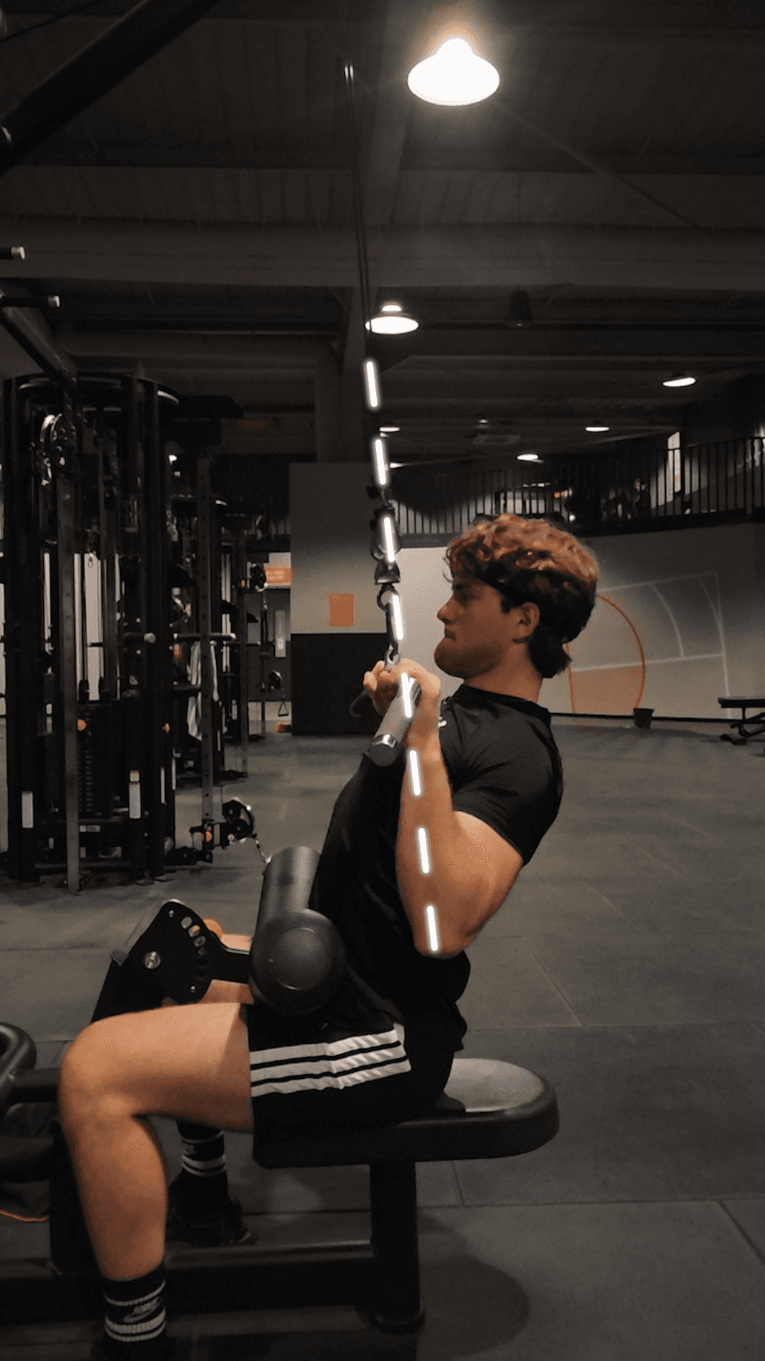 A person preparing for strength training in a gym setting, focusing on workout intensity, repetition tracking, and physical progress through a clean, motivational environment.