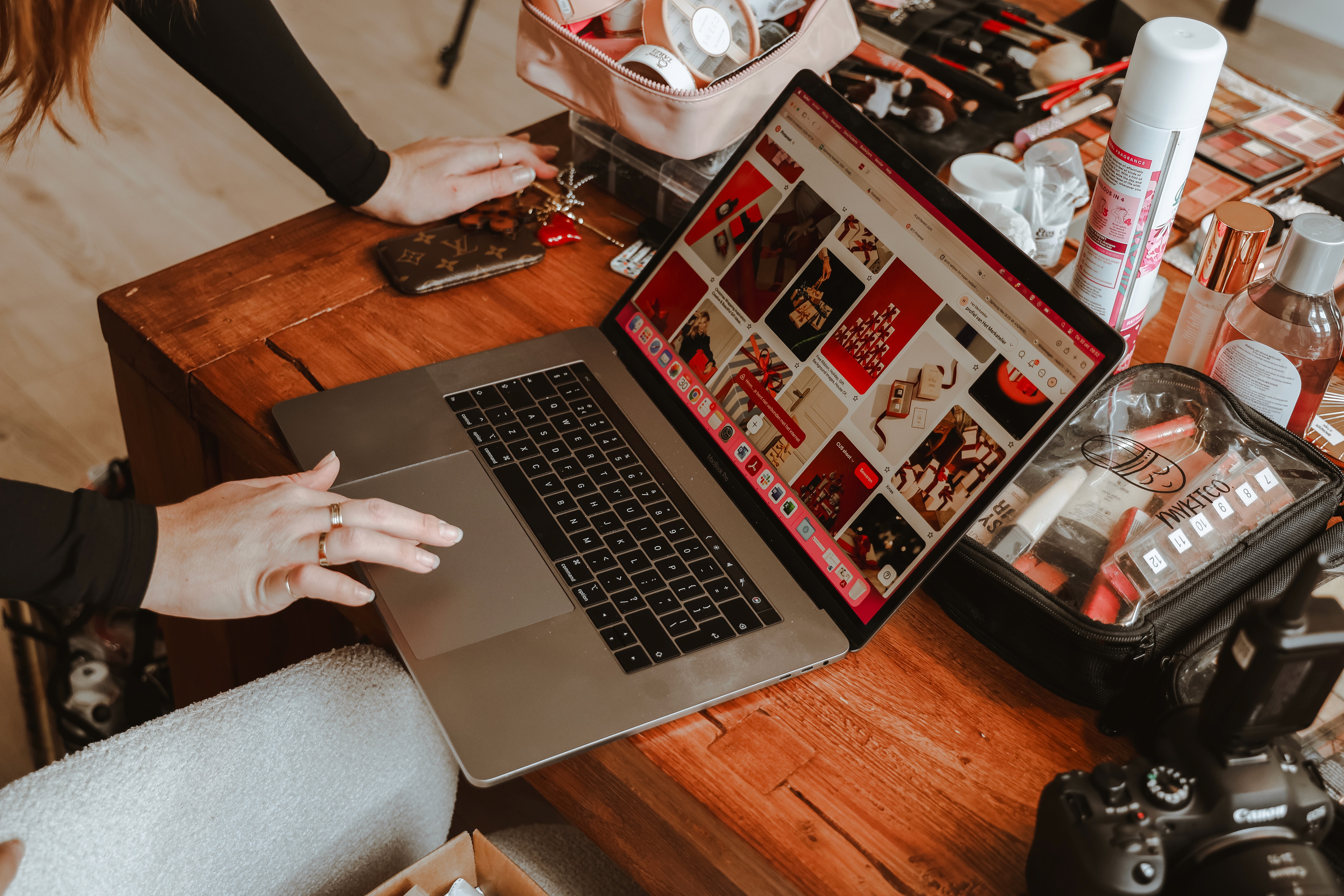 Three people sitting on a couch in a room looking at mobile devices