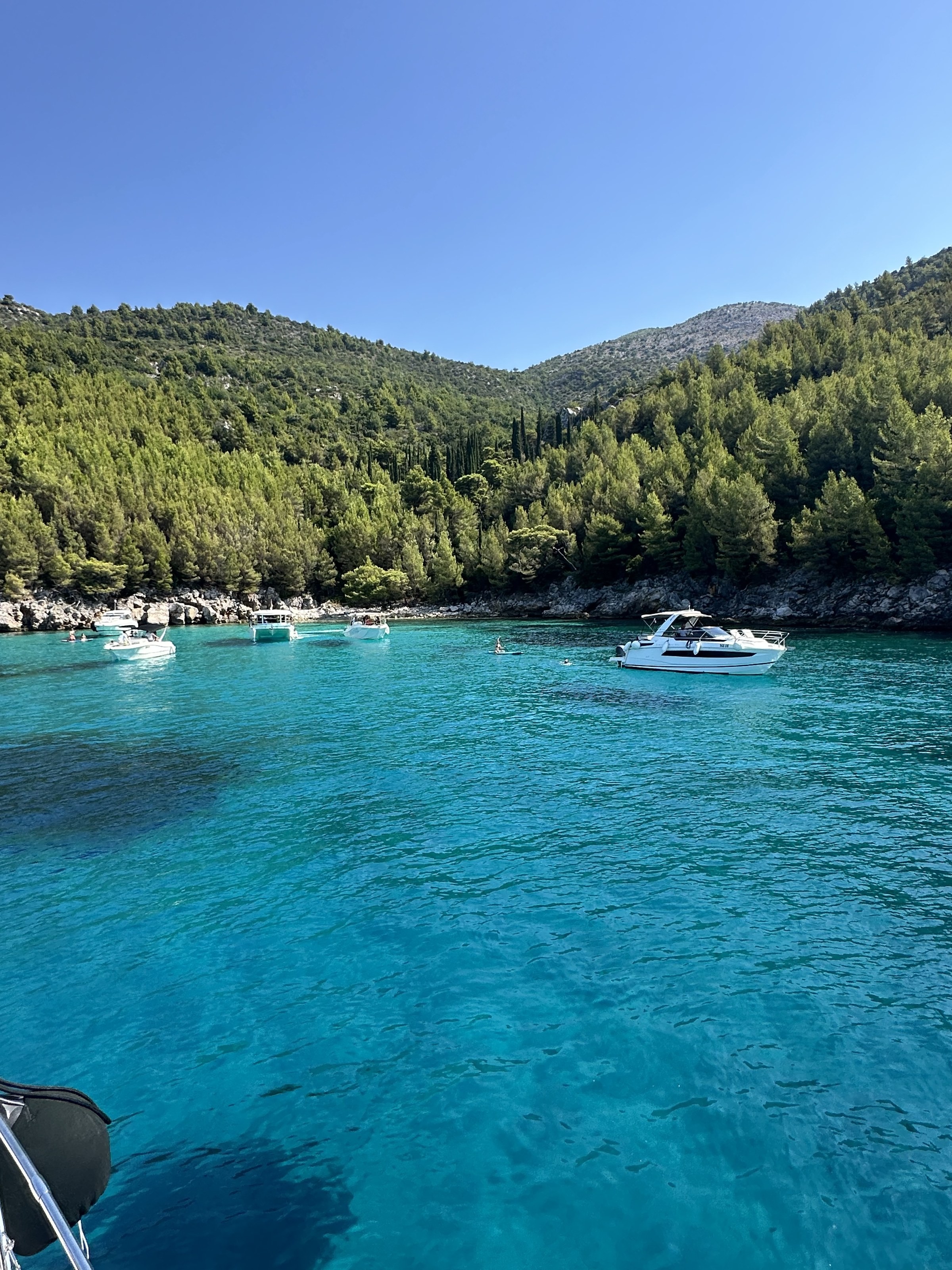 Boats anchored in a clear Adriatic cove near Dubrovnik