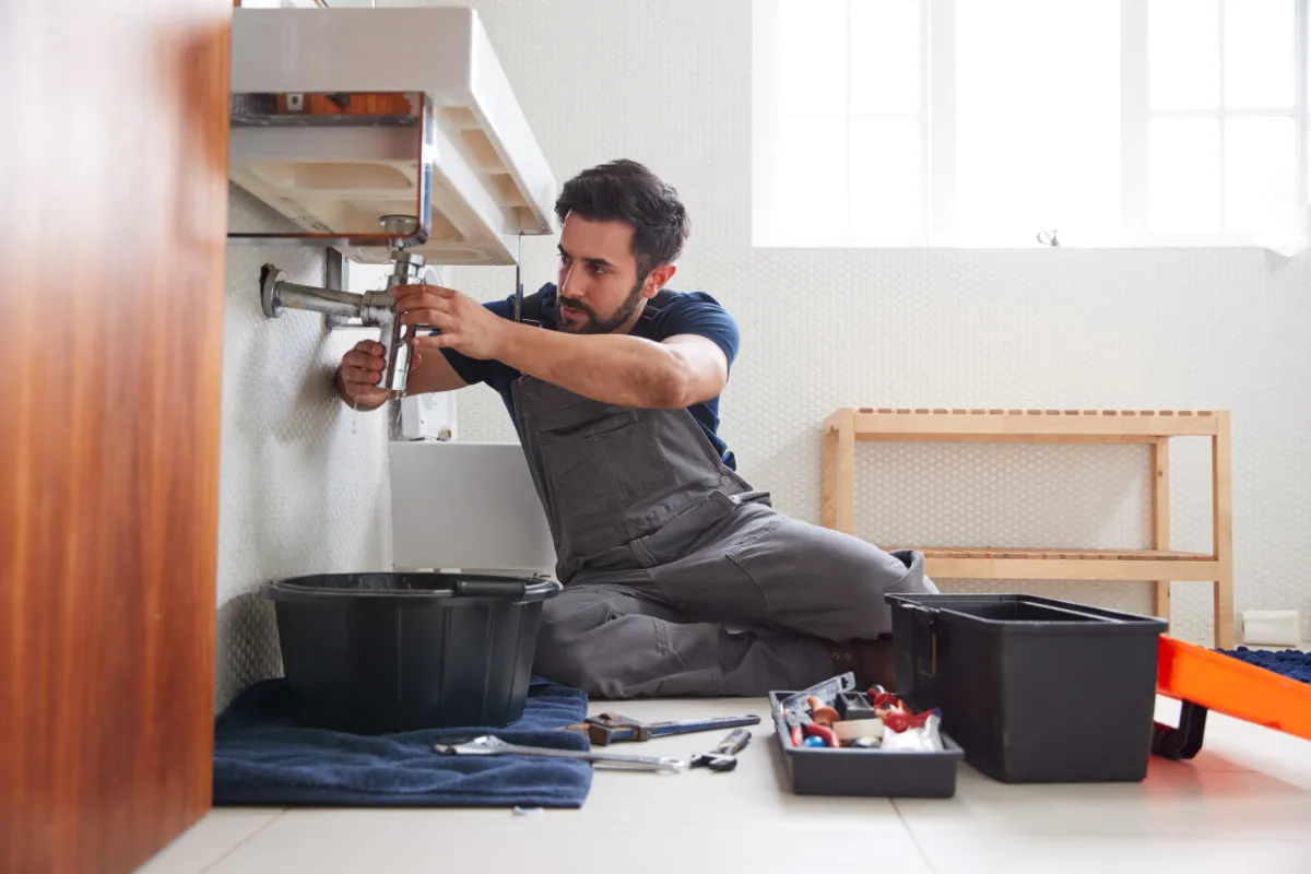 man fixing sink doing north brisbane property repairs