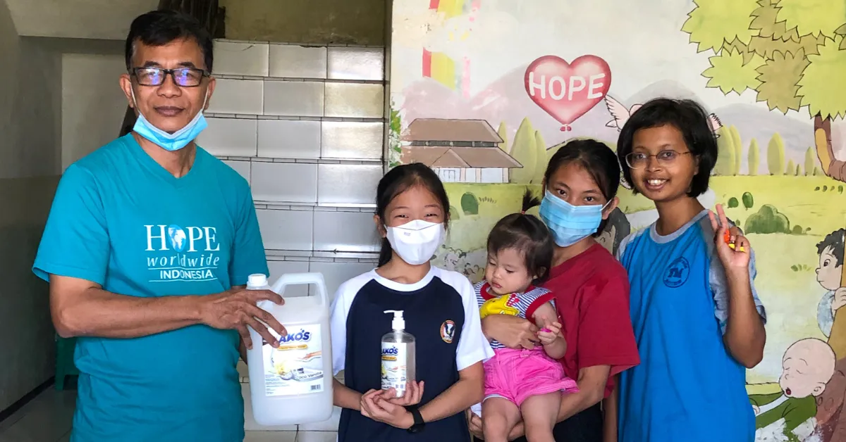 woman carrying white and green textbook