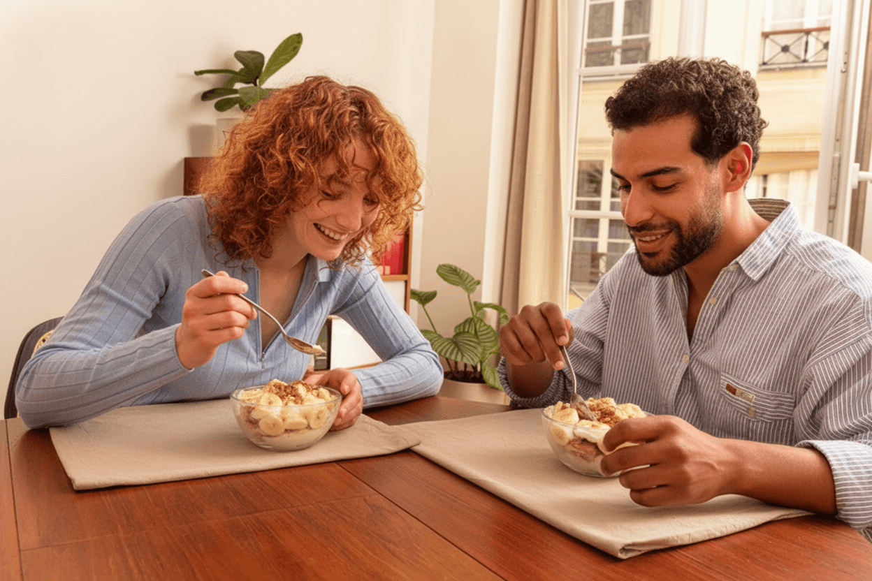 woman holding a phone and man looking at the phone. both are smiling