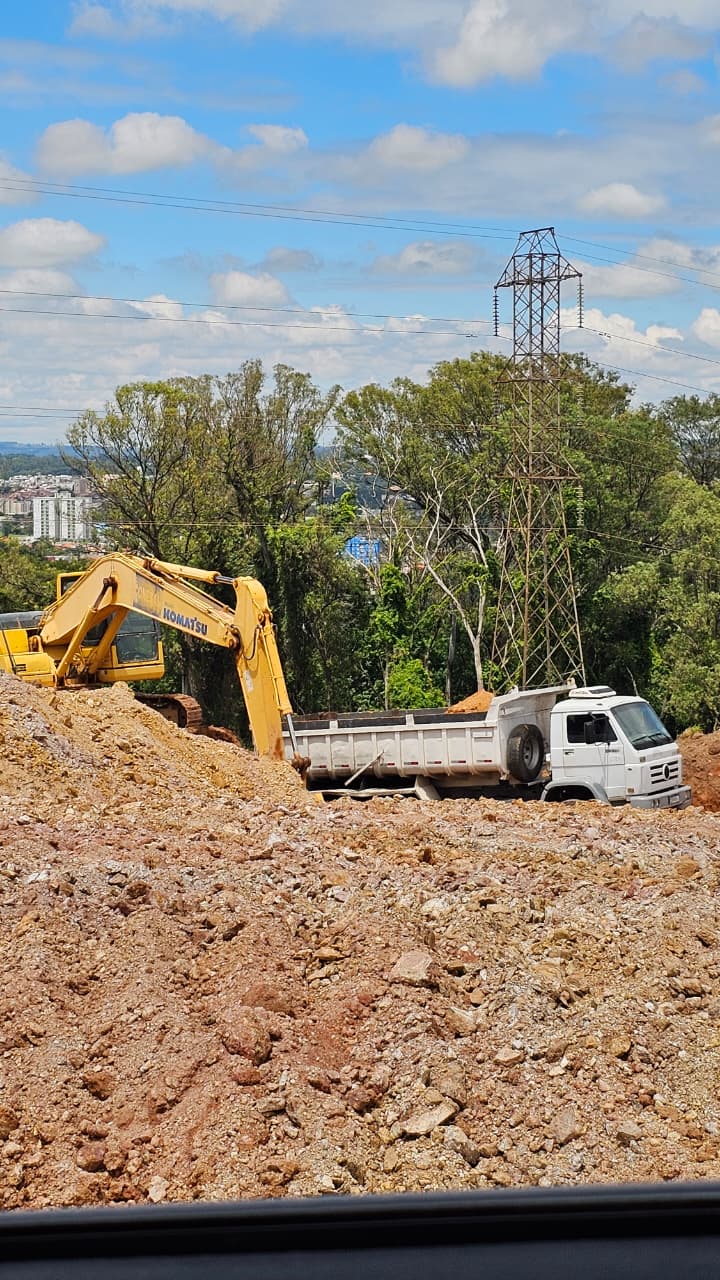 yellow and black excavator on brown soil