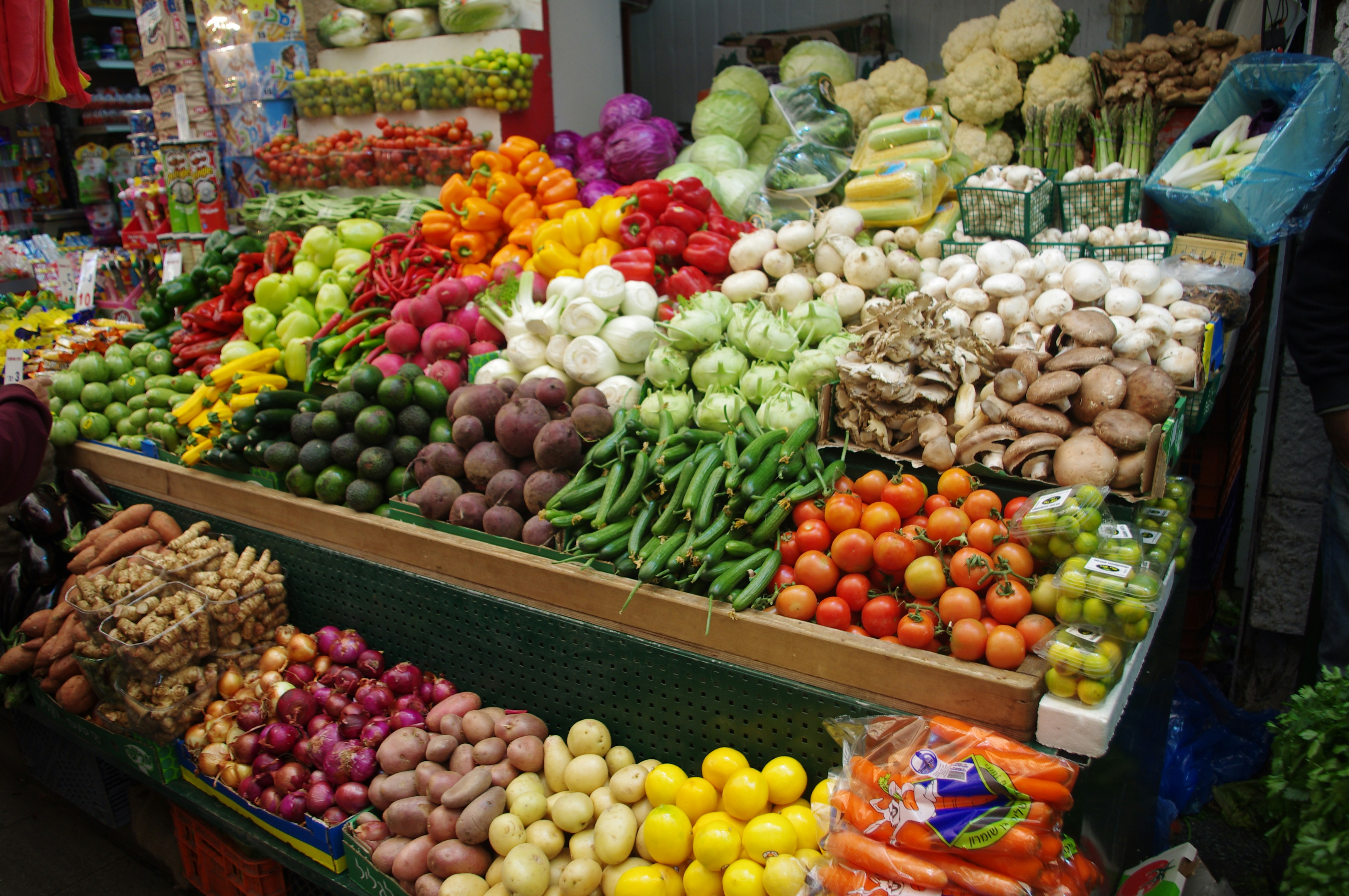 a large display of fruits and vegetables at a market