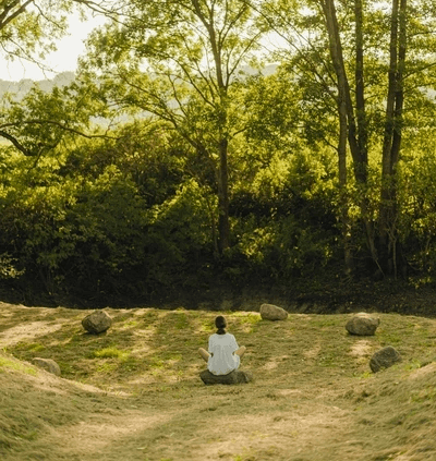 Woman meditaiting in forest