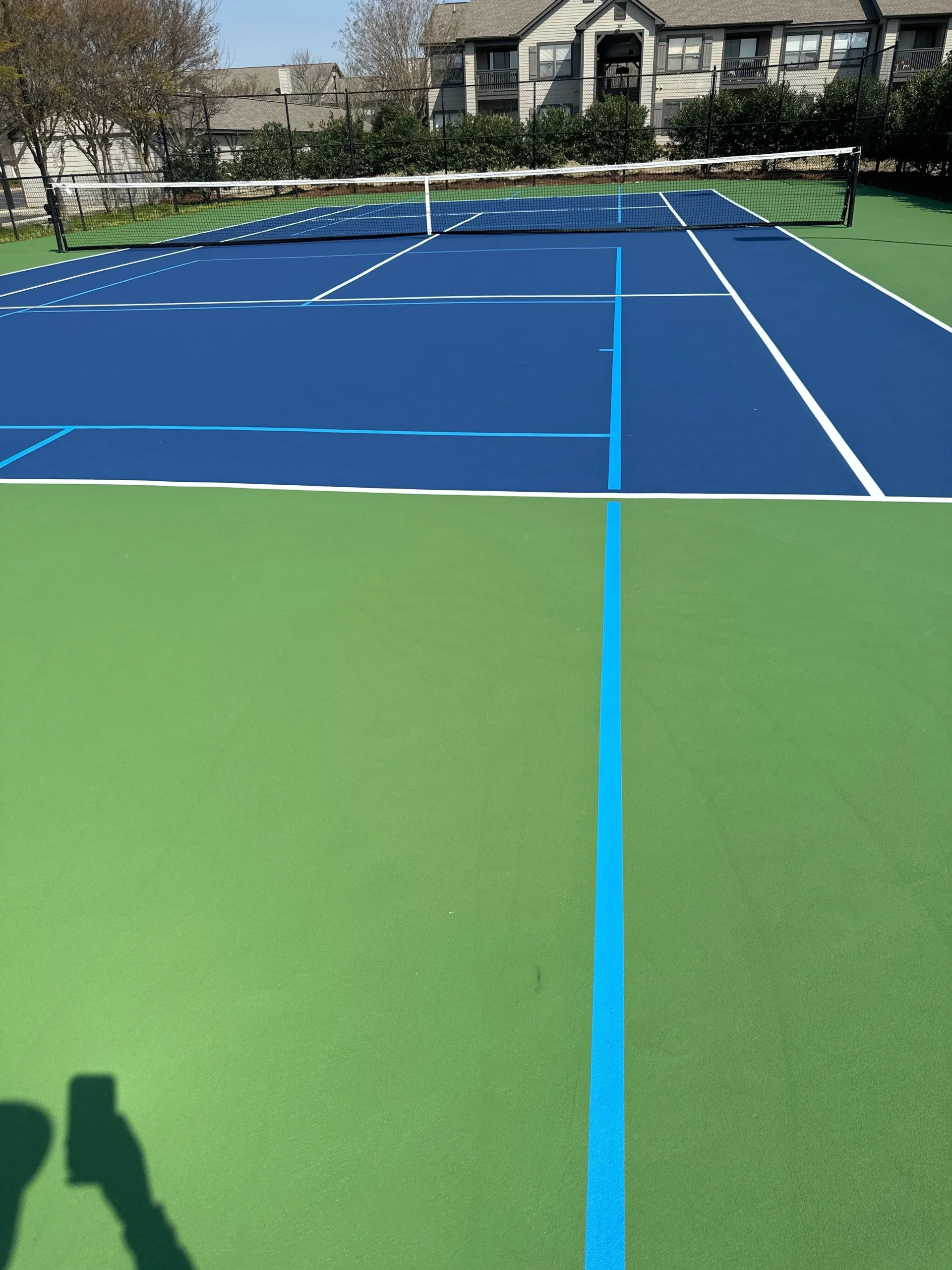 Close-up of fresh blue and green acrylic coating with light blue accent striping at Weston Ranch in Madison, AL