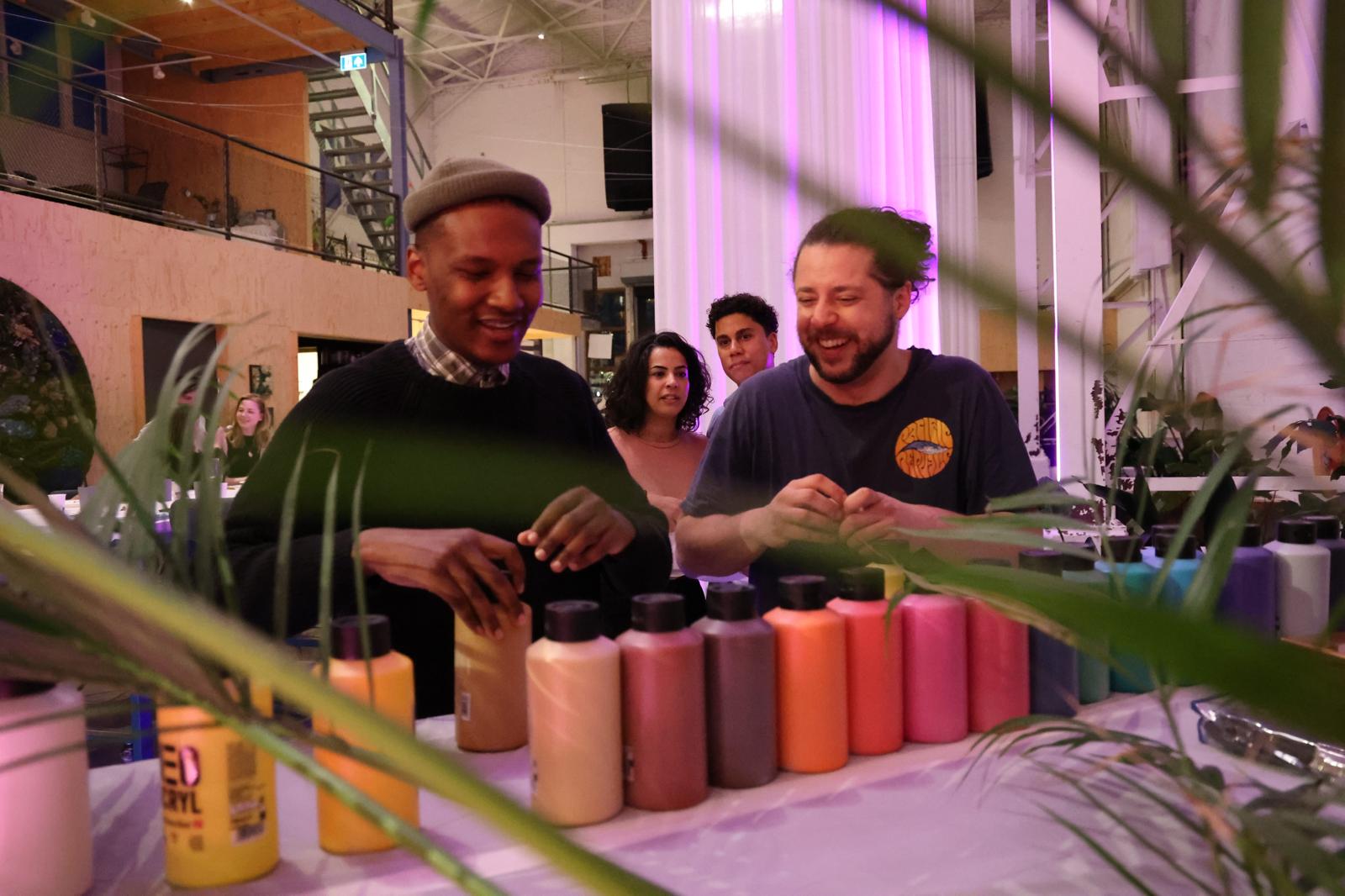 A winding road cuts through rocky terrain, surrounded by patches of green grass and illuminated by sunlight.