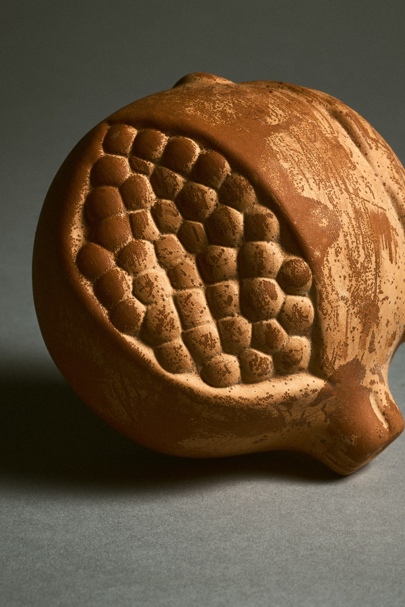 Terracotta pomegranate by Santa Maria Novella photographed for Nuevo Estilo magazine.