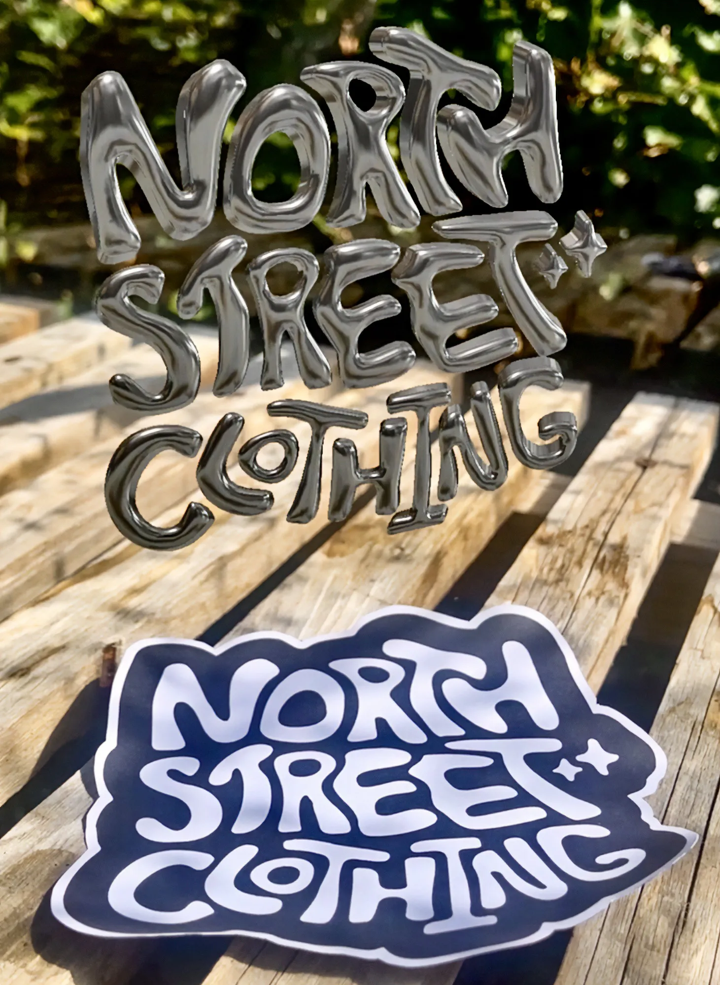 Chrome North Street Clothing lettering and sticker on a sunlit wooden table