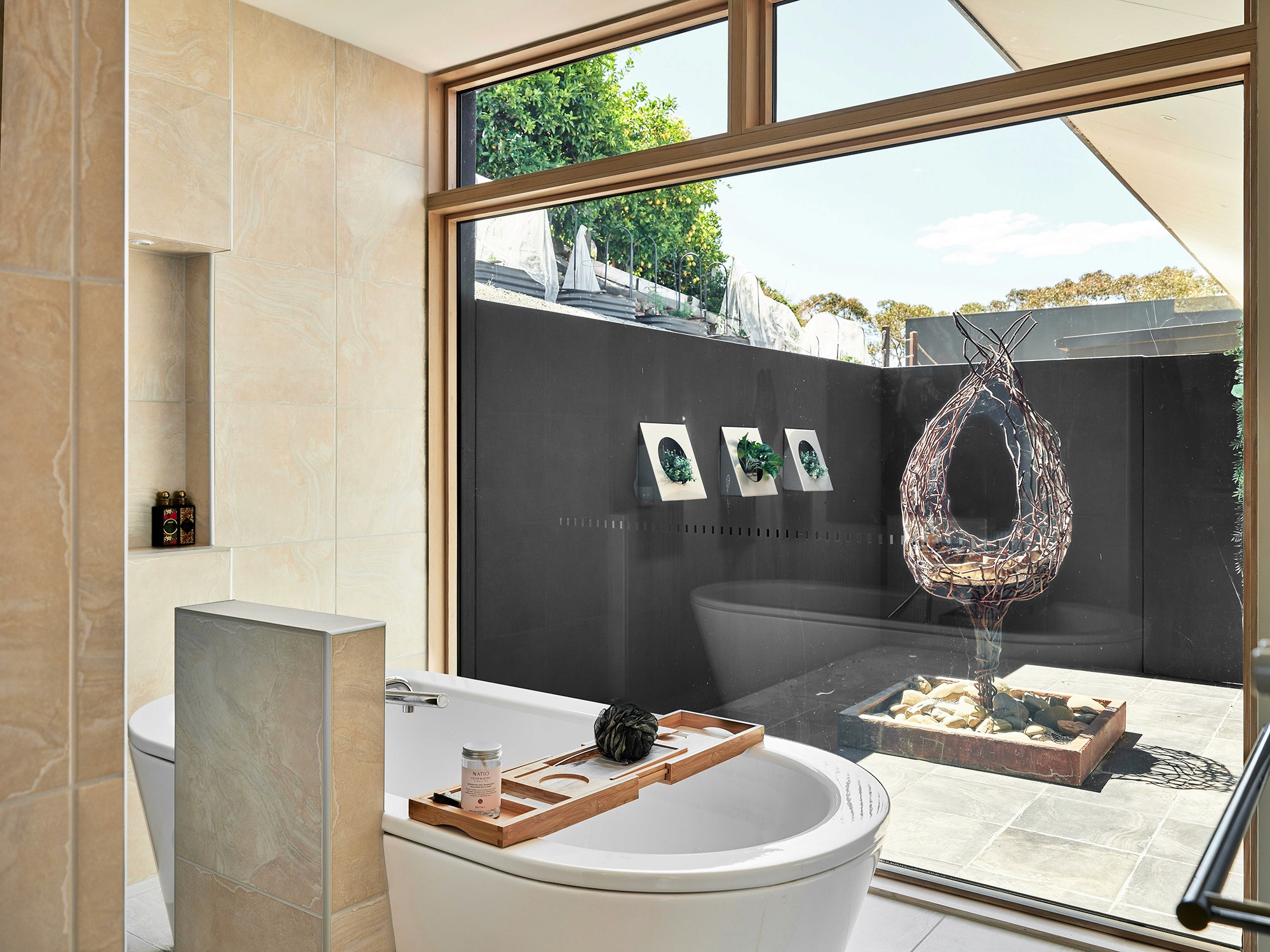 Modern hillside home with terracotta urn and mountain view