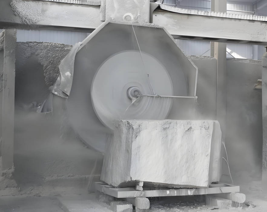 The Dinosaw Bridge Single-Blade Cutting Machine in operation, demonstrating its powerful blade cutting through a large stone block with ease, showcasing the machine's efficiency and cutting capability.