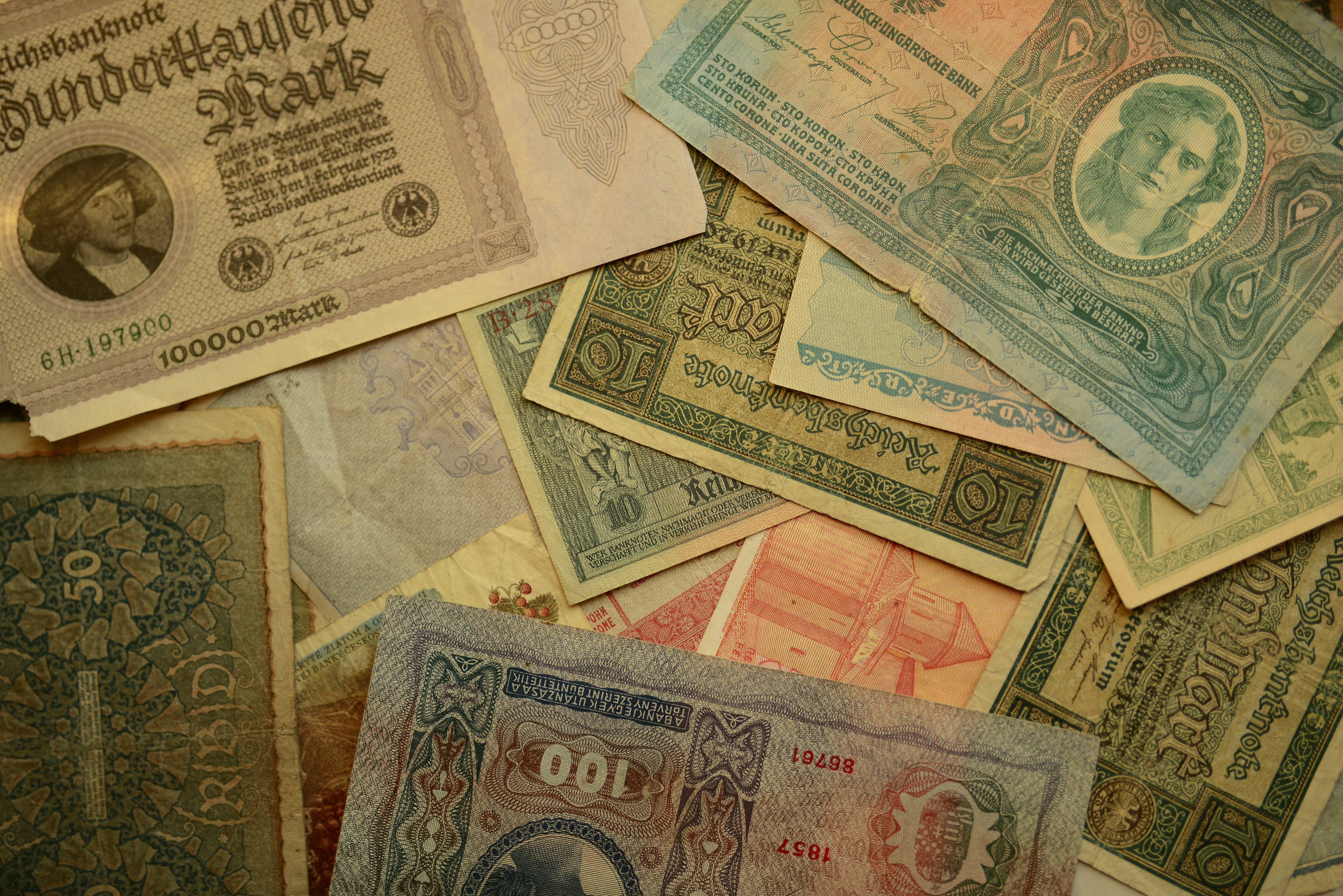 a pile of different types of currency