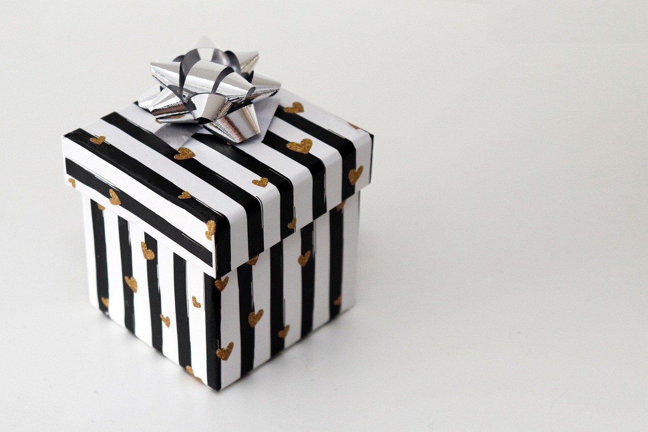 a black and white box with a bow on it