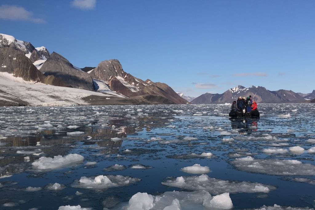 Small boat amongst ice in Svalbard