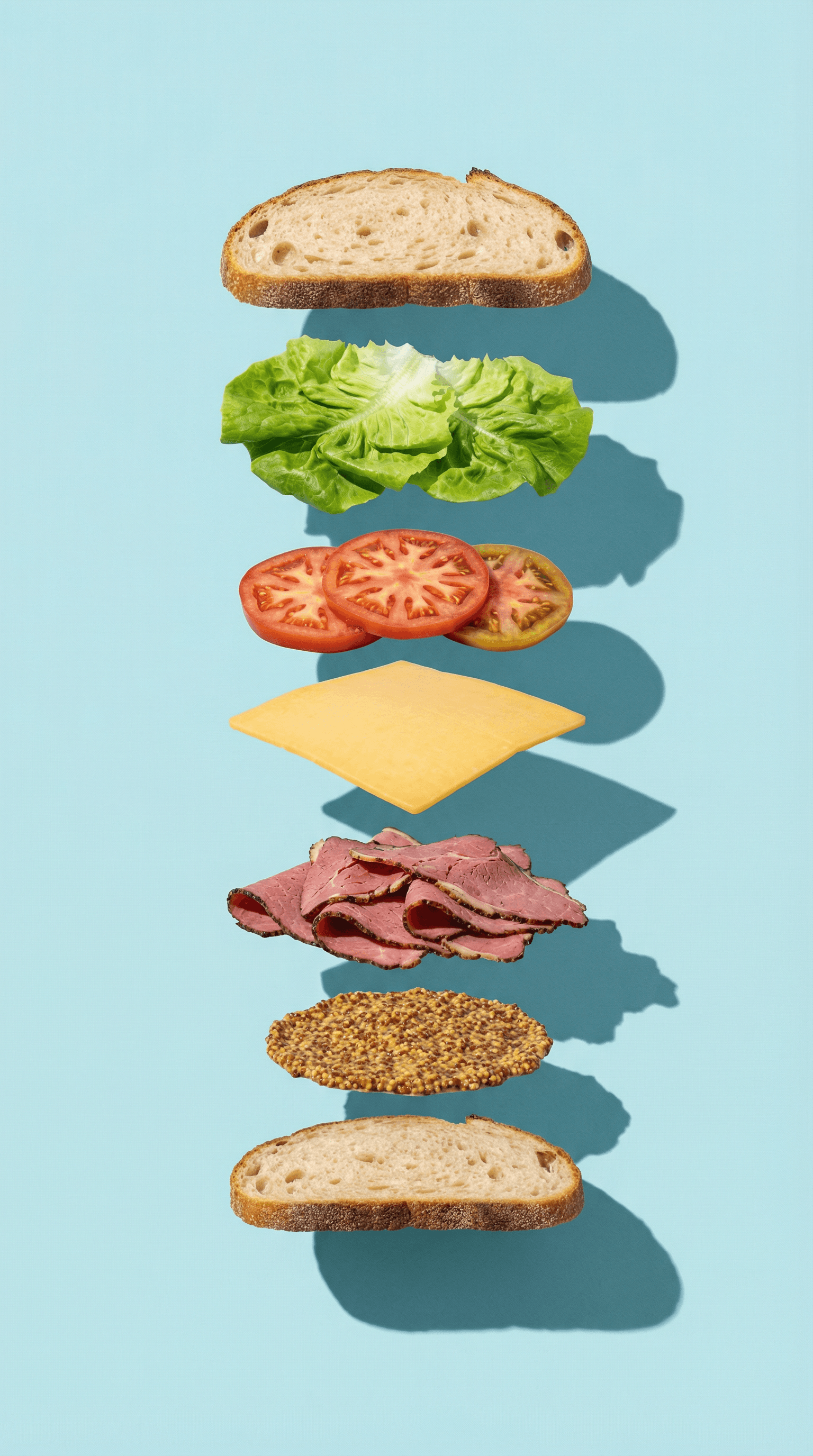Floating sandwich layers with bread, lettuce, tomato, cheese, mustard, and sliced meat.