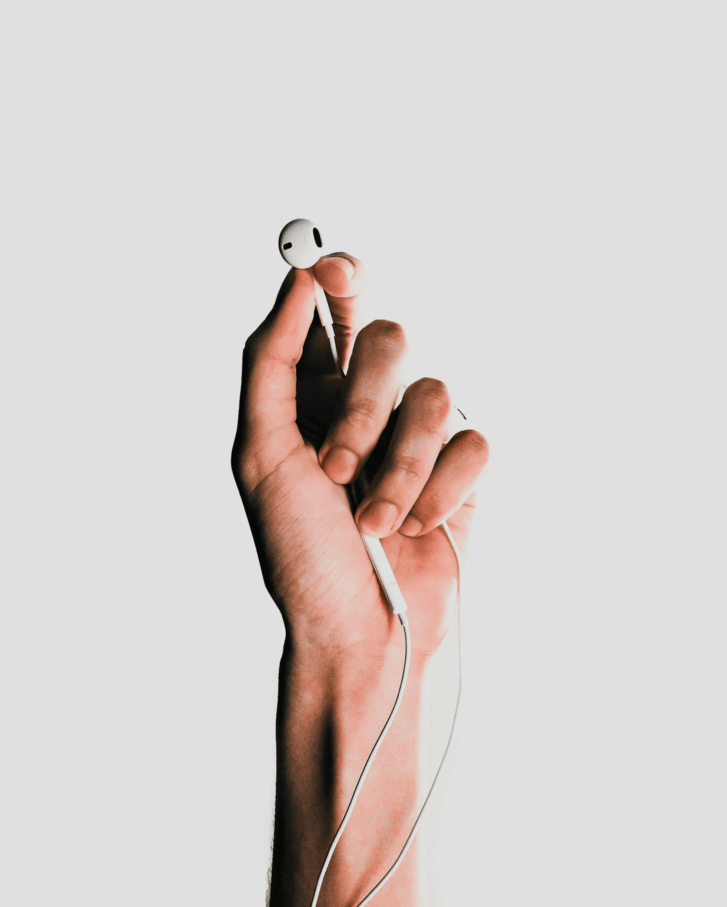 person holding Apple EarPods