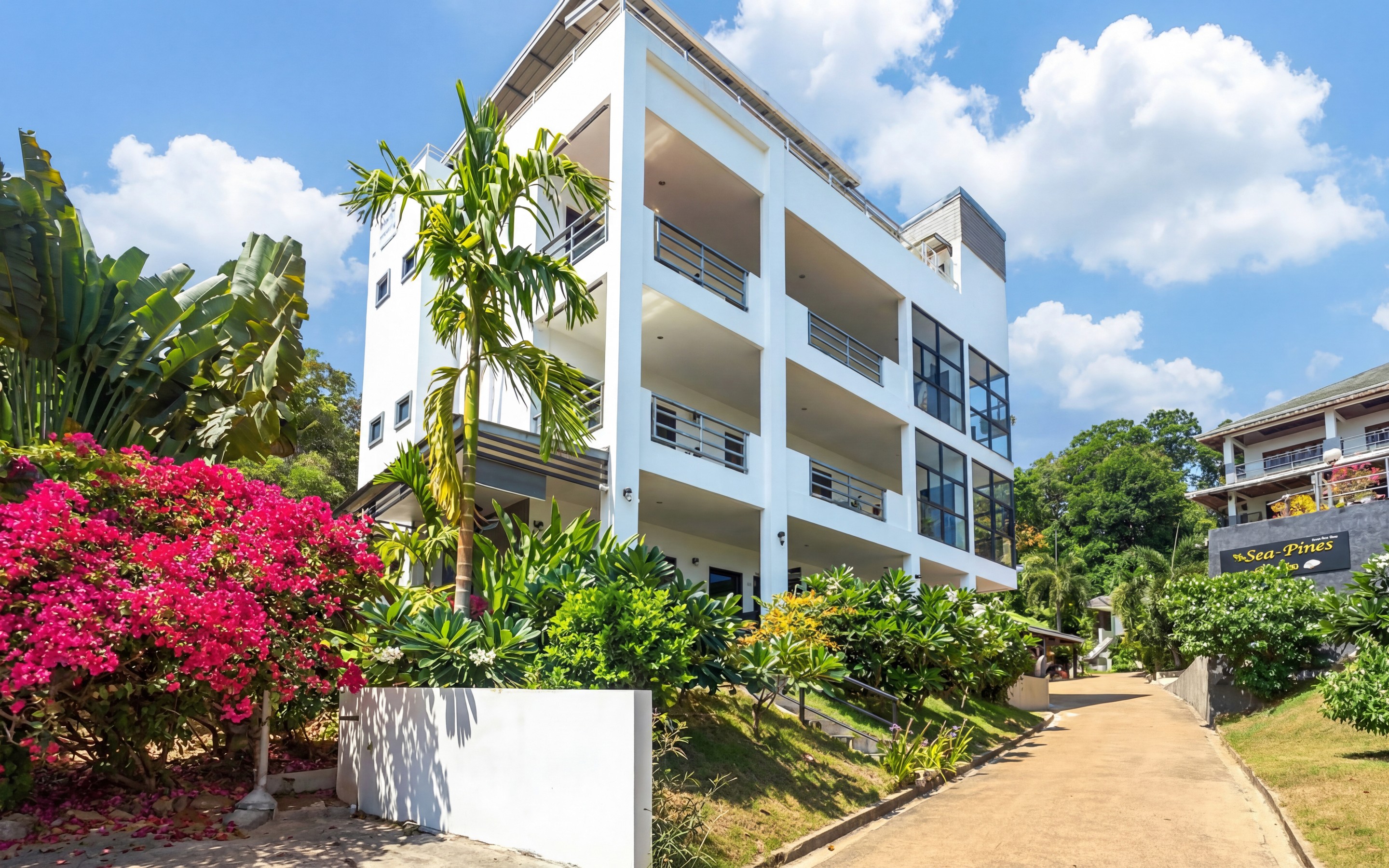 Low-rise residential buildings on Ko Lanta, surrounded by tropical plants and quiet local streets.