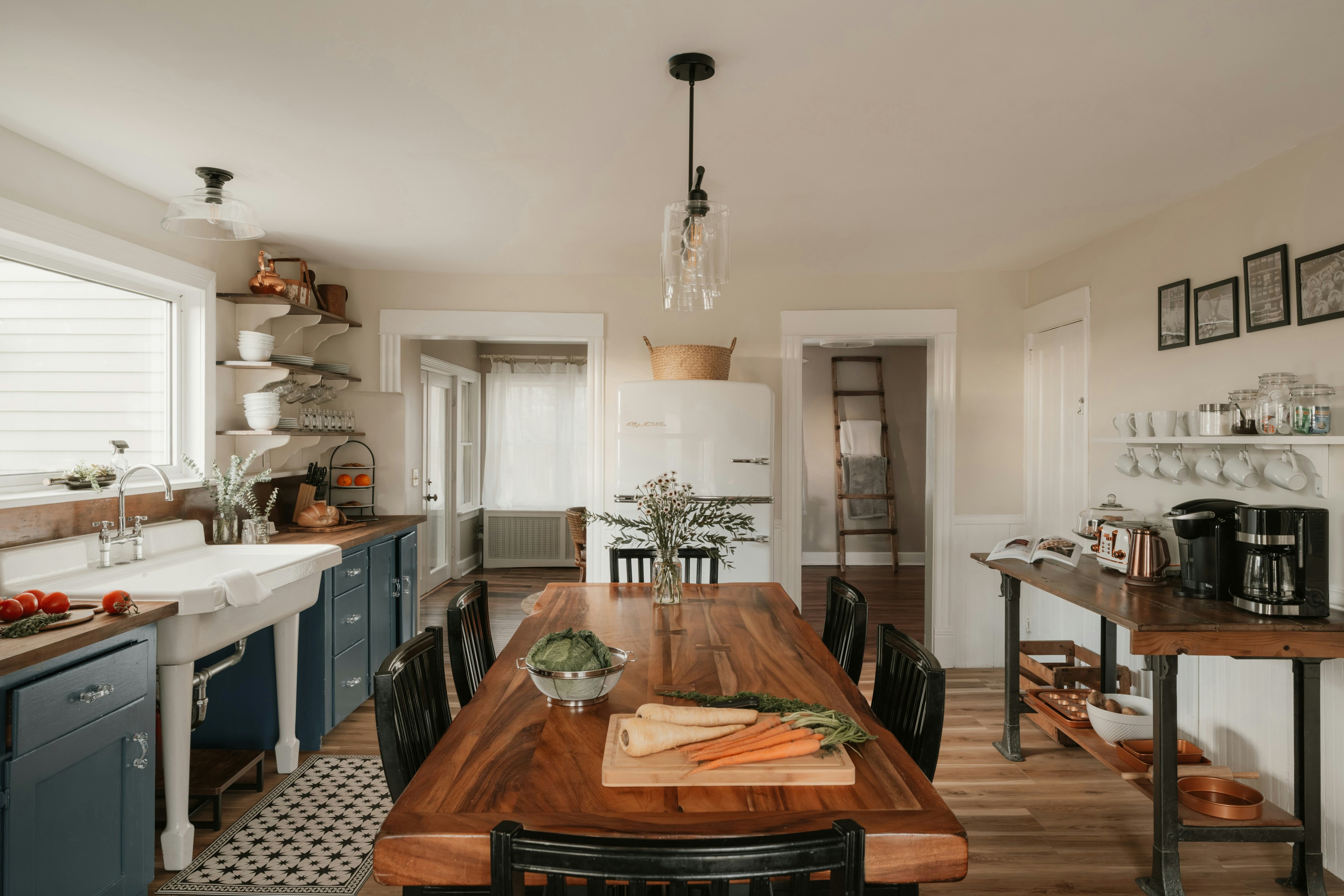 A kitchen with a long wooden dining table