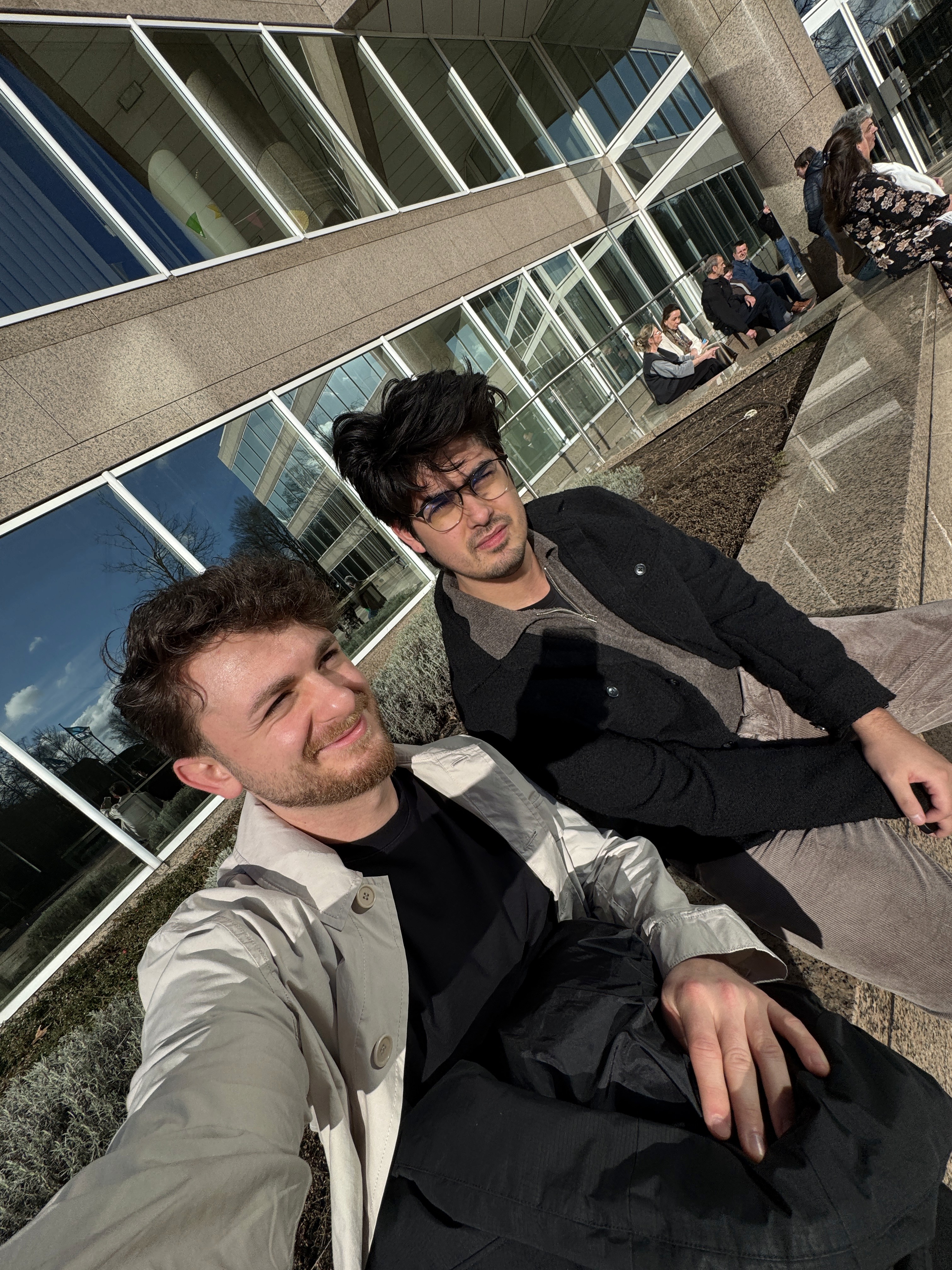 Person sitting on a ledge overlooking New York City skyline