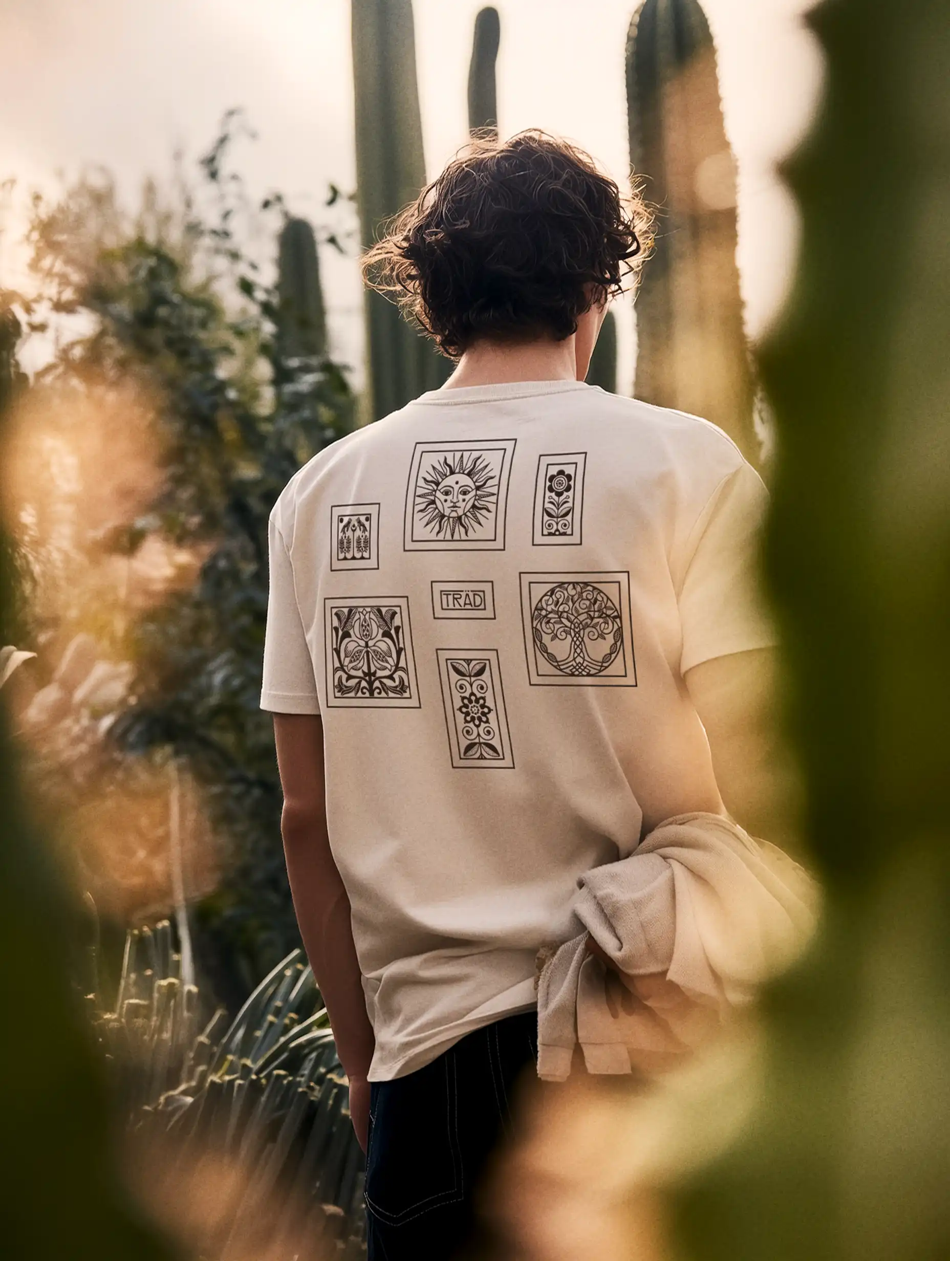 Side view of the model standing with relaxed posture, showcasing the flowing lines of her outfit and the room’s clean architecture.