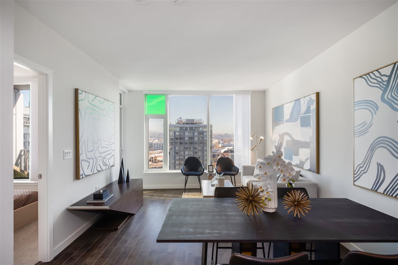 Modern office space featuring a large desk, minimalistic decor, and bright natural light from a window.