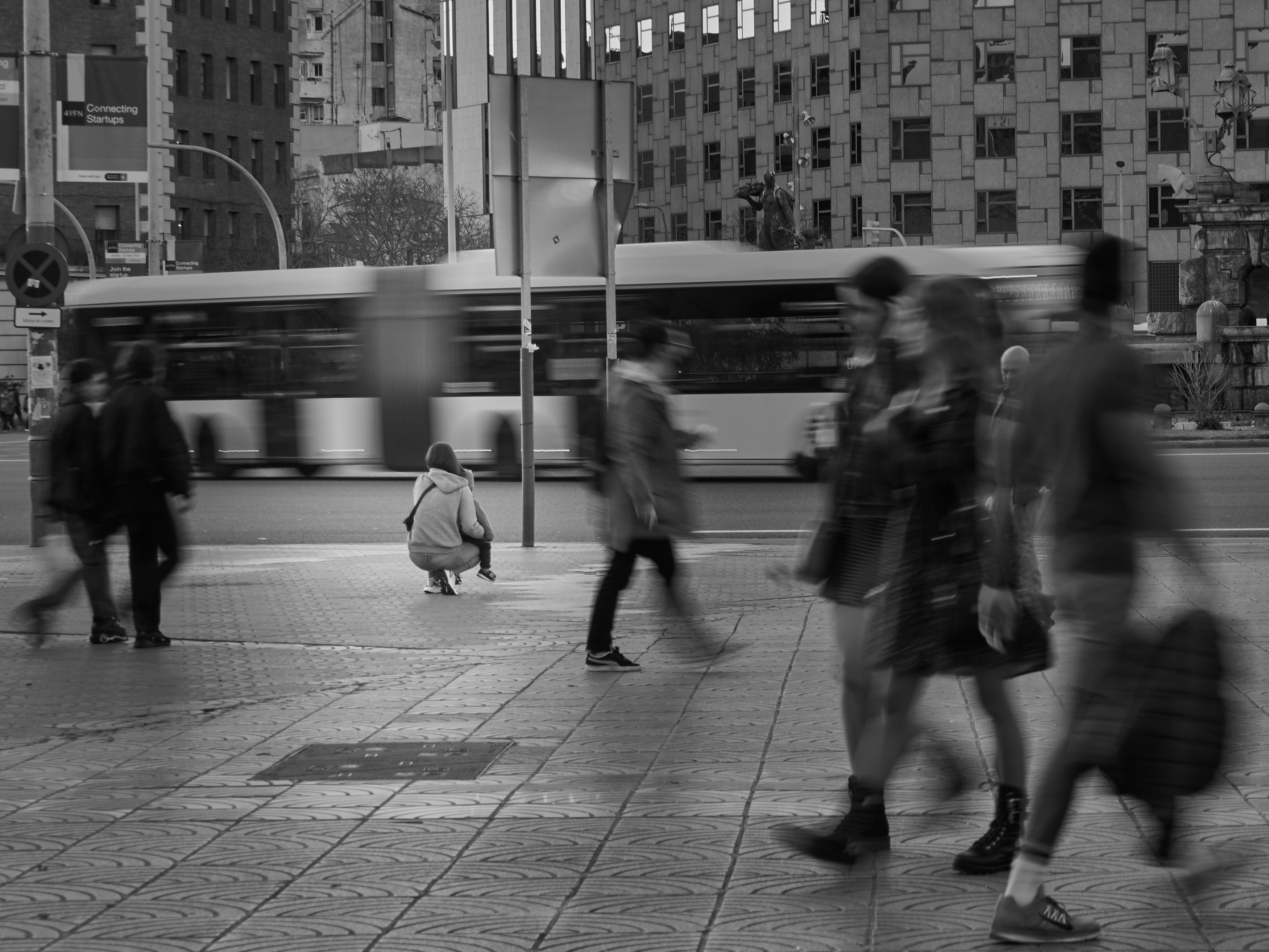 a group of people walking across a street