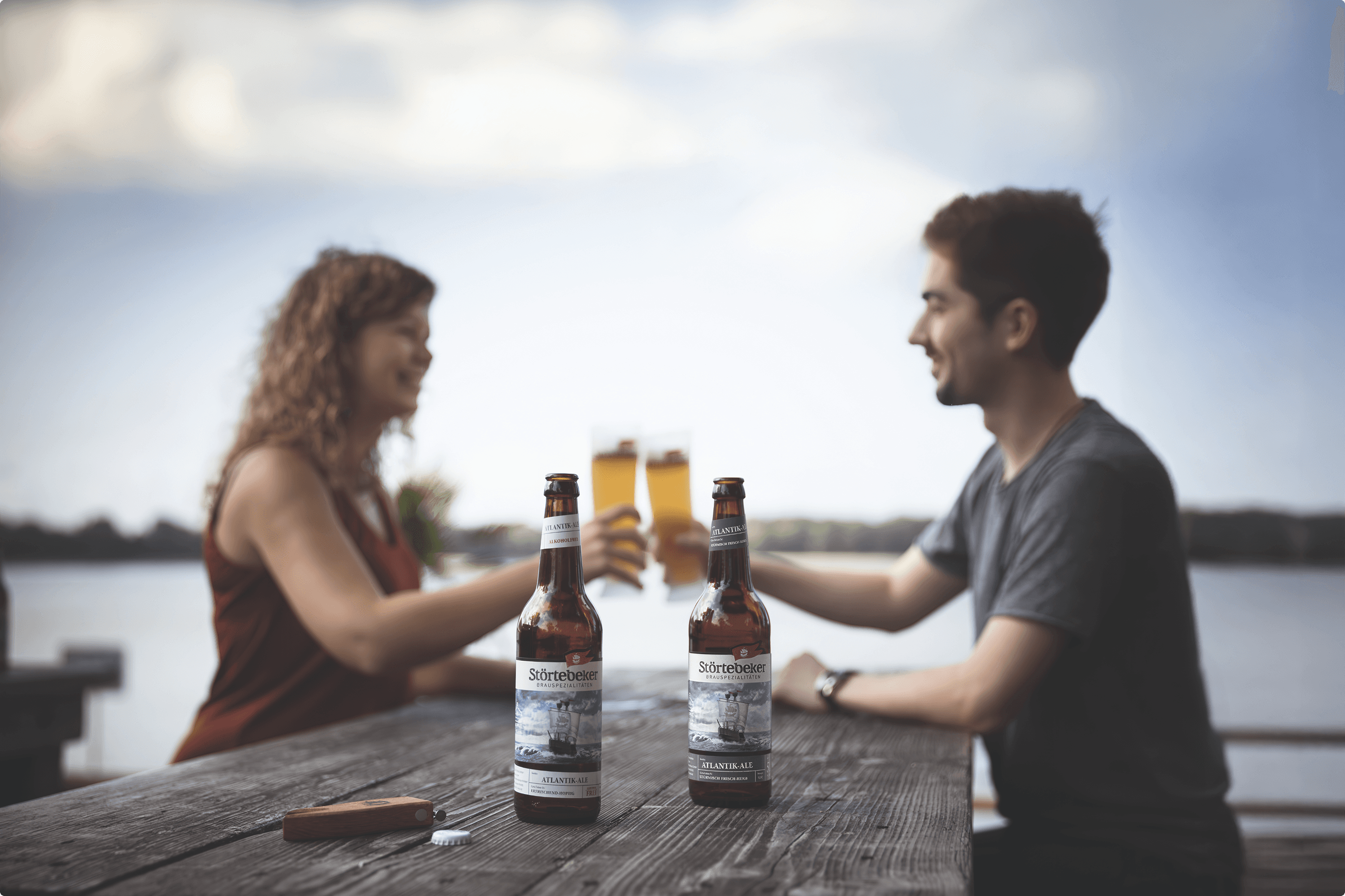 Couple toasting with beer bottles and glasses