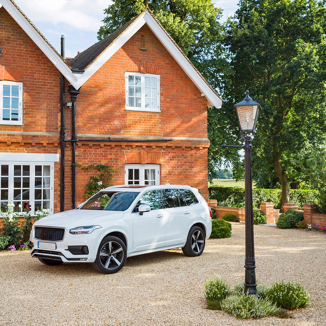 Image of a UK house in need of security measures, with a white premium car parked in front