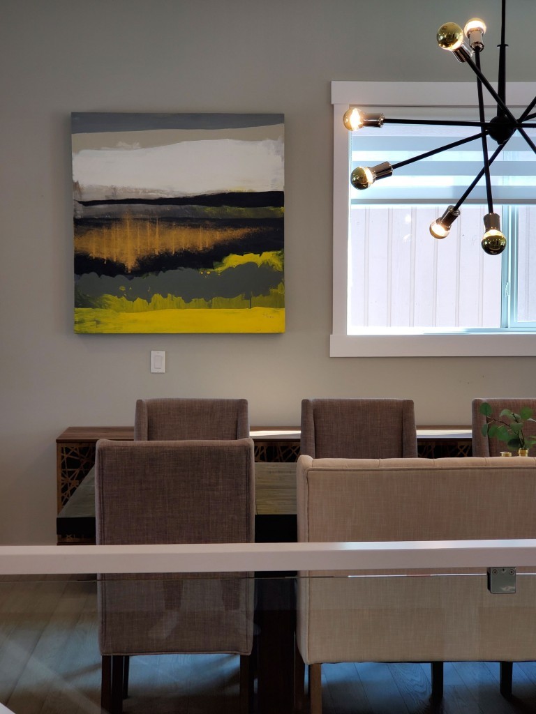 Image of Modern dining room interior with abstract art, stylish furniture, and sleek lighting by KHD Homes.