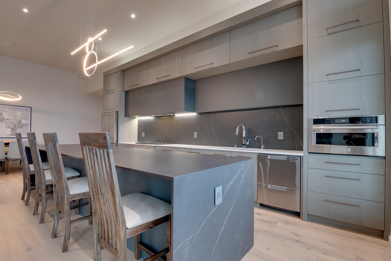 Open-concept kitchen with island and bar stools