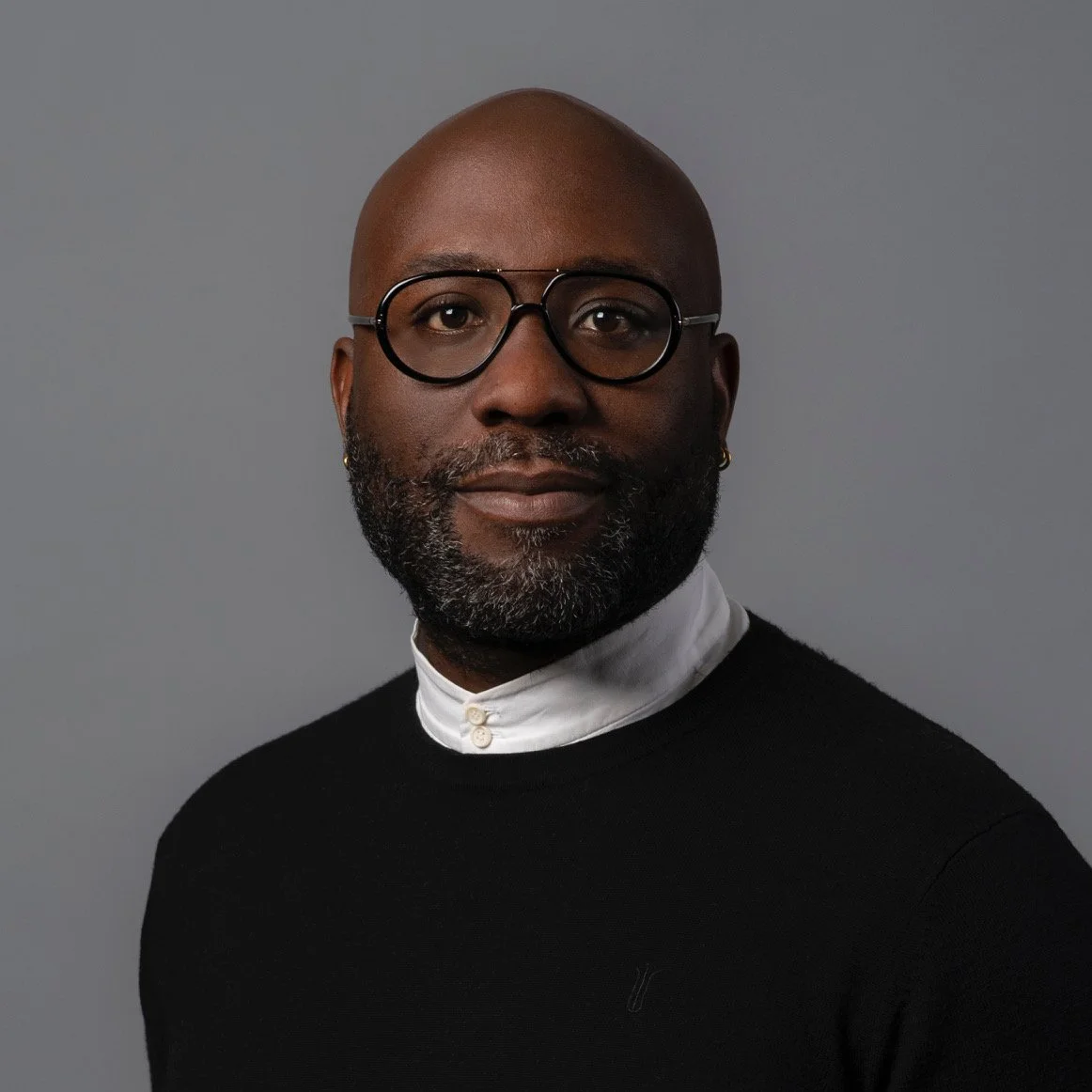 a woman with long blonde hair wearing a black shirt