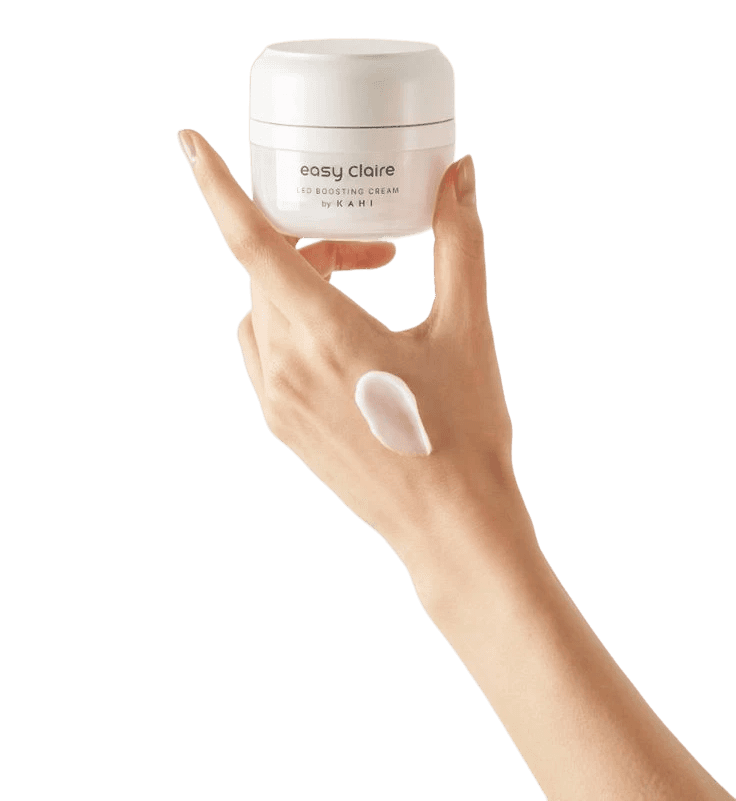 Hand holding face cream jar on white background