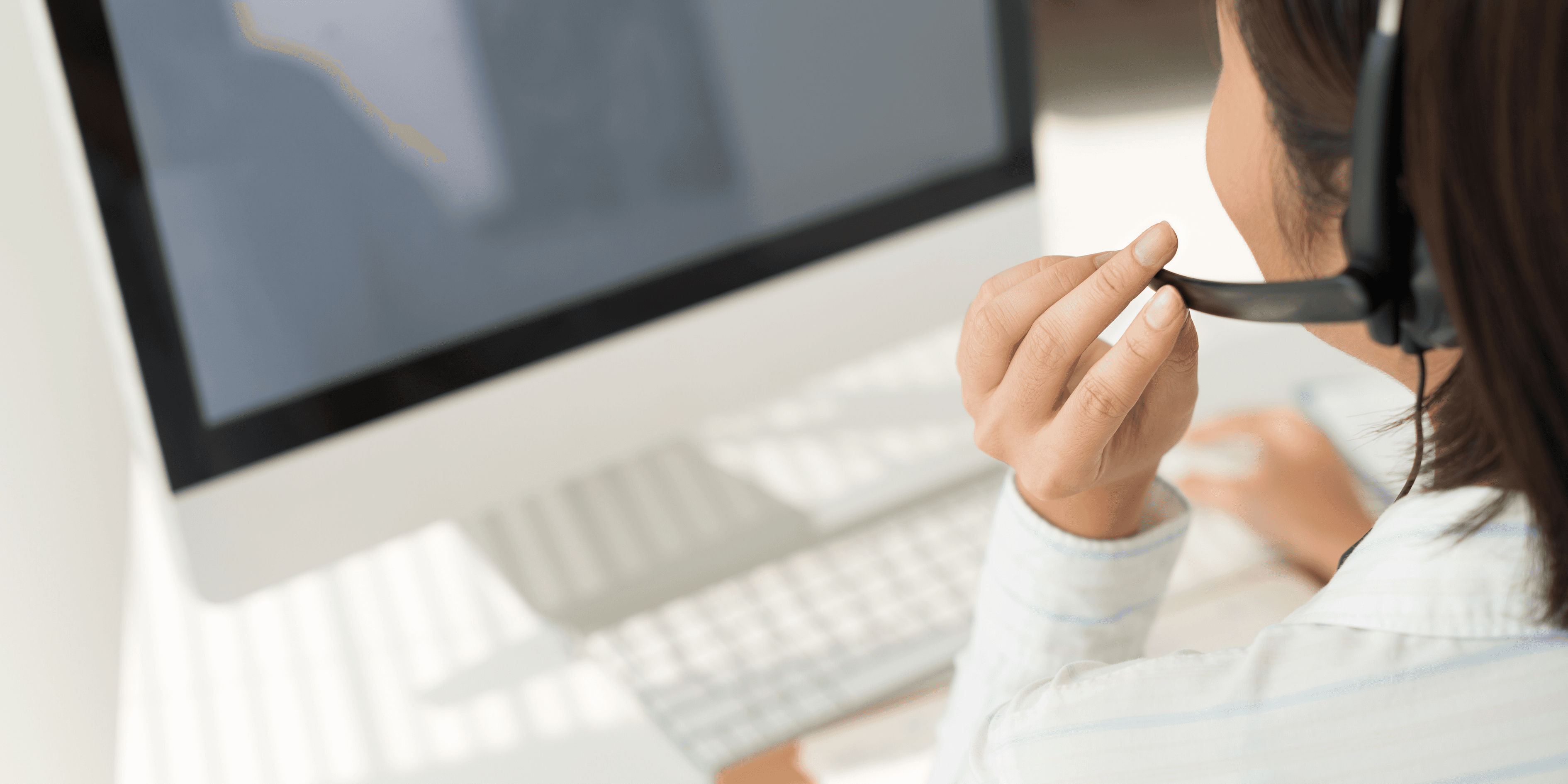 two people in a workspace working on their laptops 