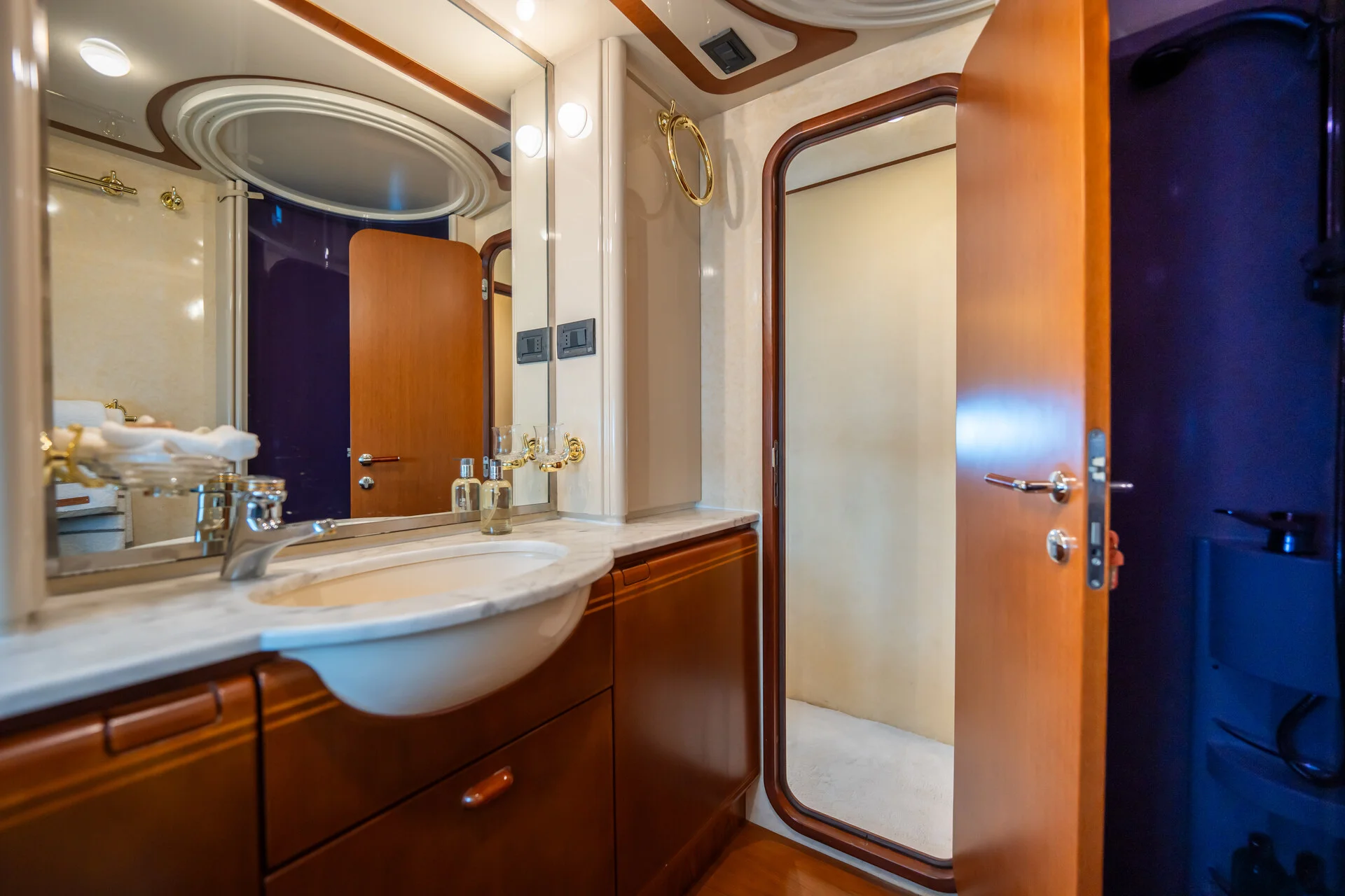 White Rock 36 speedboat with captain at helm cruising calm blue waters near Paros coastline with hills in background.