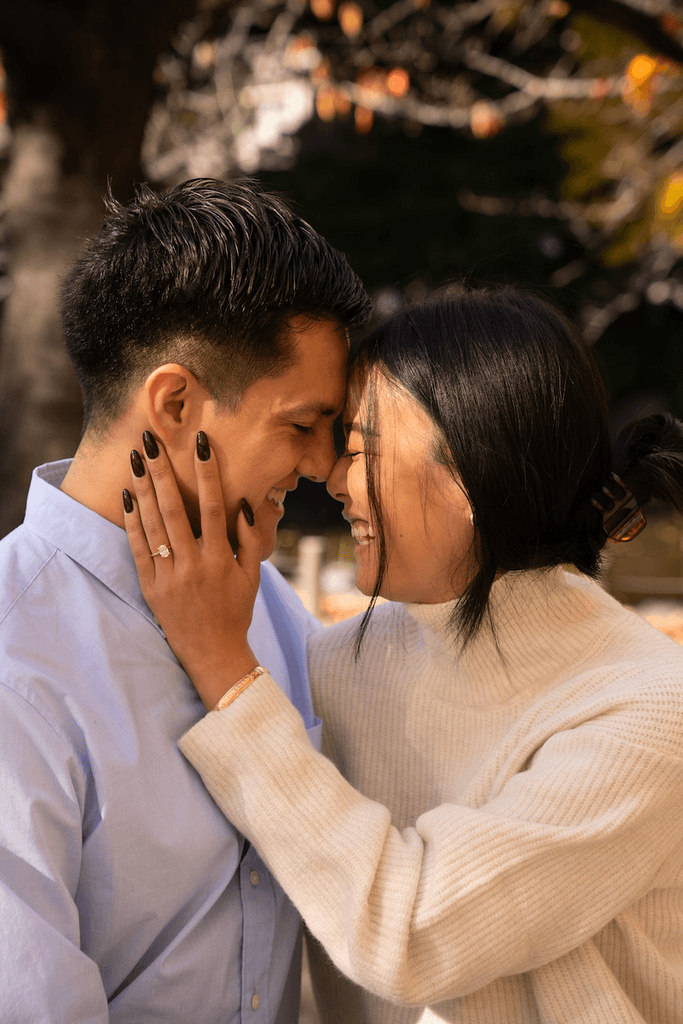 Couple embracing in autumn engagement photoshoot