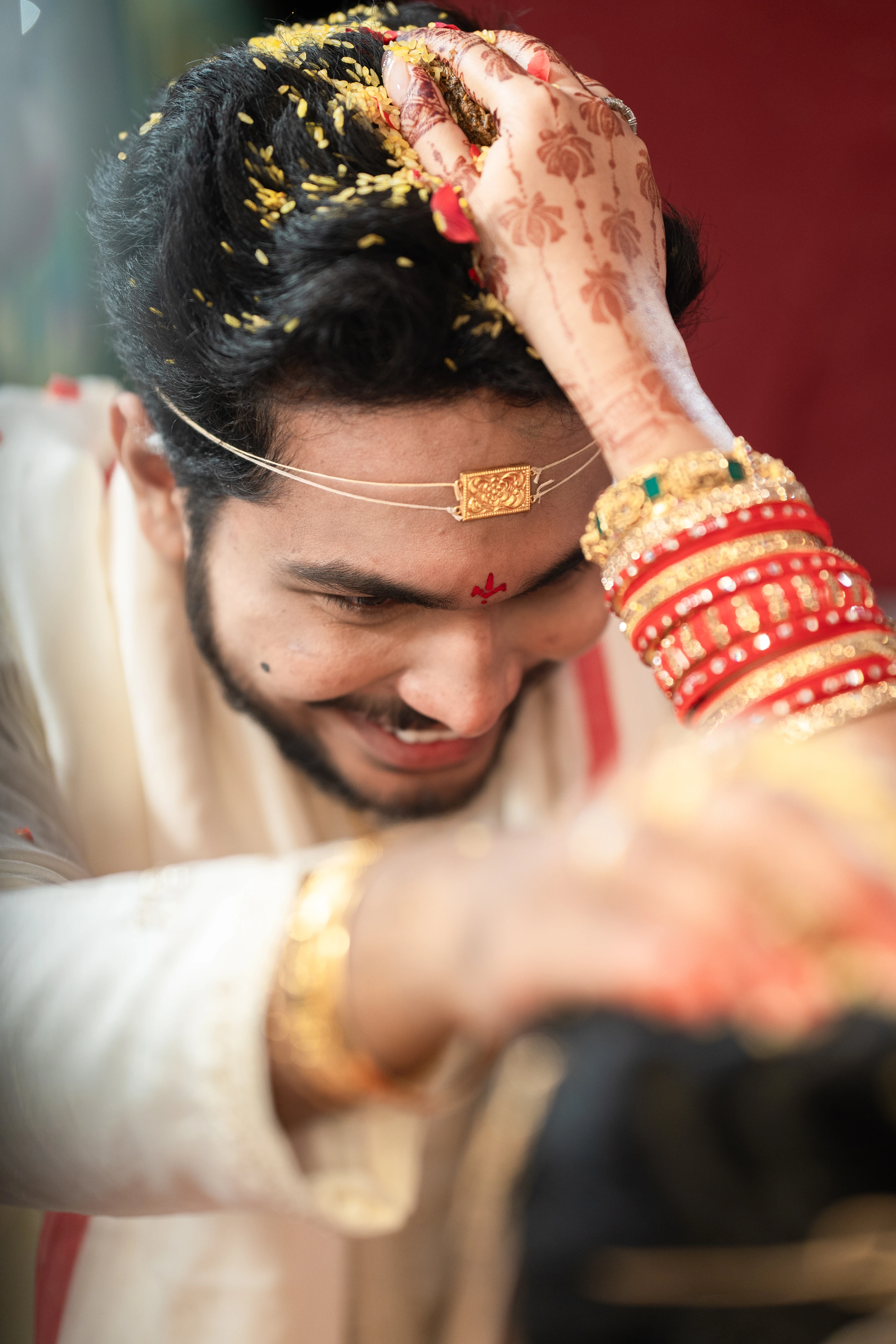 Fine Art Wedding Photography in Hyderabad by Out of The Blues capturing the heartfelt moment of Rohit and Lovely exchanging sindoor during their wedding ceremony.