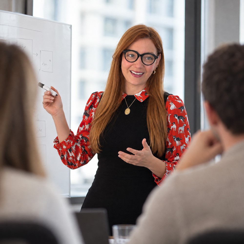 A Climbing Trees team member presenting at a whiteboard