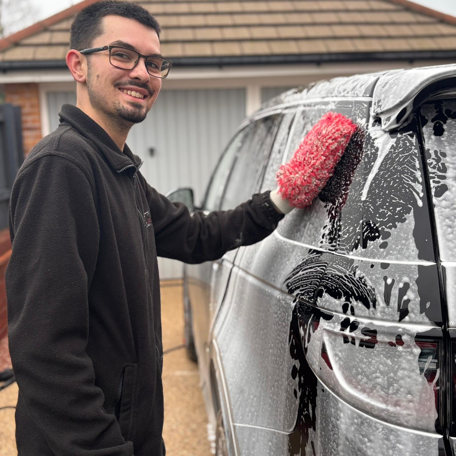 a man working on a car in a garage